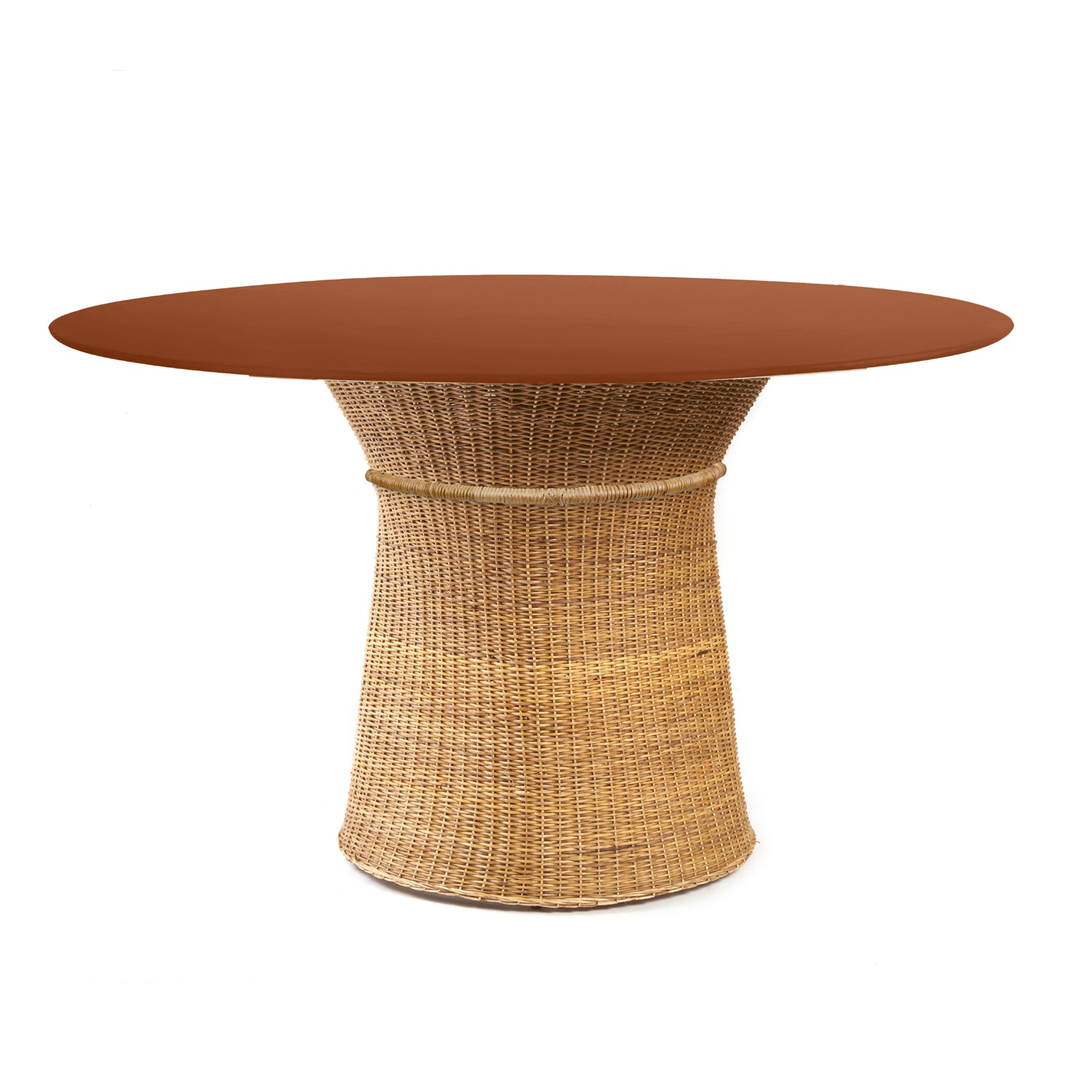 The Ames Caribe Natural Dining Table by Ames features a round, smooth reddish-brown top and a natural wicker base that flares out at the bottom, photographed against a white background—an elegant piece inspired by Sebastian Herkner’s designs.