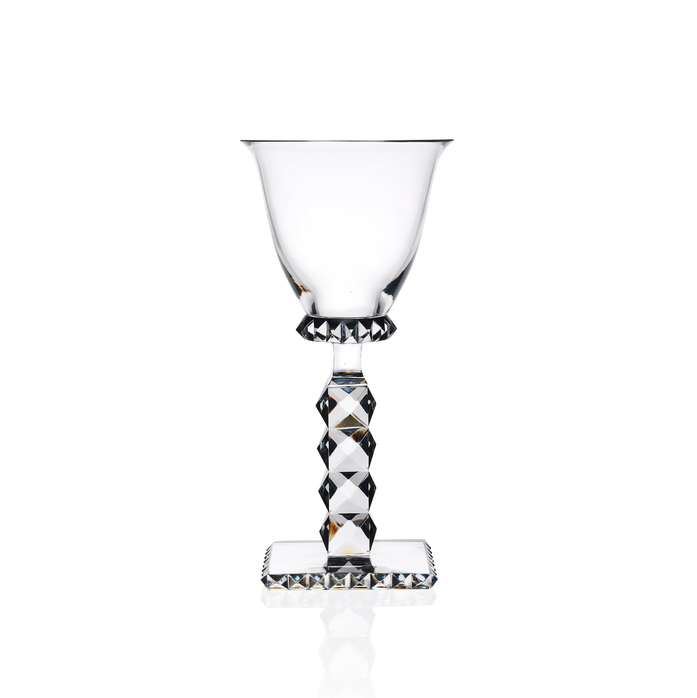 The Lobmeyr Hoffmann Goblets are clear, mouth-blown, lead-free crystal wine glasses featuring faceted stems and square bases. Designed by Josef Hoffmann, they have an elegant geometric pattern that beautifully reflects light for a sophisticated look against a white background.