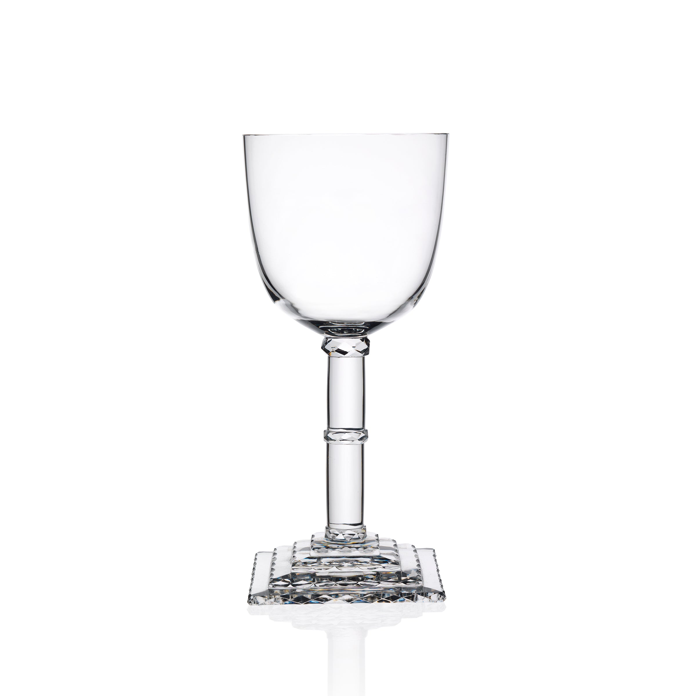 The Lobmeyr Hoffmann Goblets feature a clear, empty wine glass with an ornate stem and square base reminiscent of Josef Hoffmanns design. Mouth-blown from lead-free crystal, they subtly reflect light, showcasing their elegant craftsmanship against a white background.