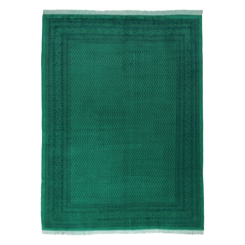 The Kiskan Color Carpet #92, a rectangular green rug made from 100% wool, features intricate dark green geometric patterns and decorative borders, drawing inspiration from the Indo Mir style. It has short white fringes on the shorter ends.
