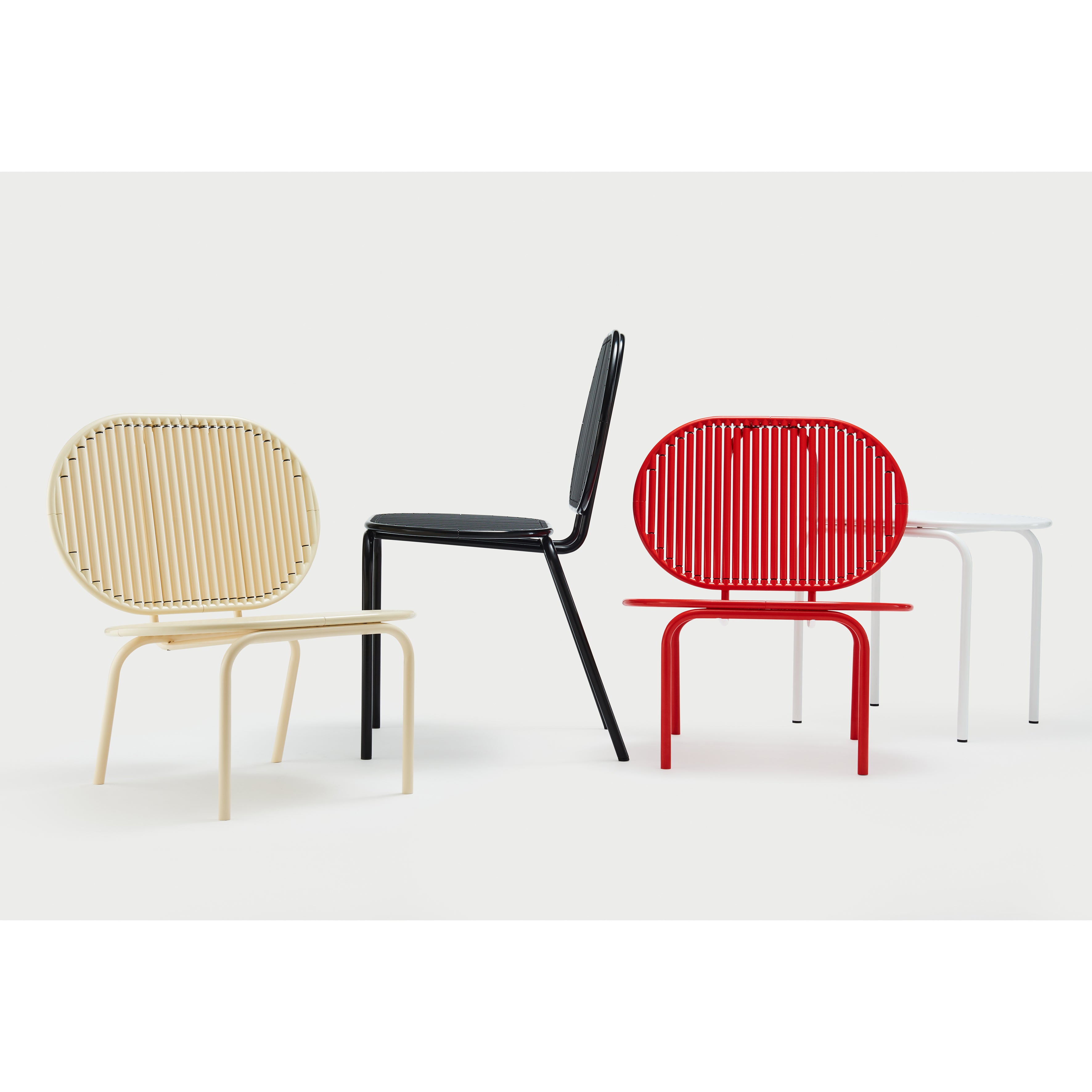 Four contemporary AKTTEM Roll Chairs with metal frames and slatted round backs are set against a light background. Designed in Germany, these chic chairs come in beige, black, red, and white with four legs featuring a simple yet elegant design.