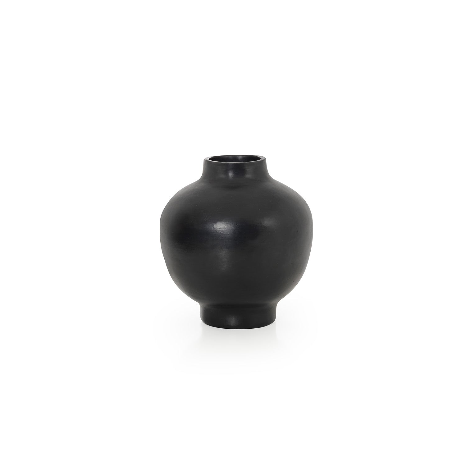 The Ames Barro Vase by Ames is a round, matte black ceramic vase inspired by handmade Colombian ceramics, featuring a small top opening and shown against a plain white background.