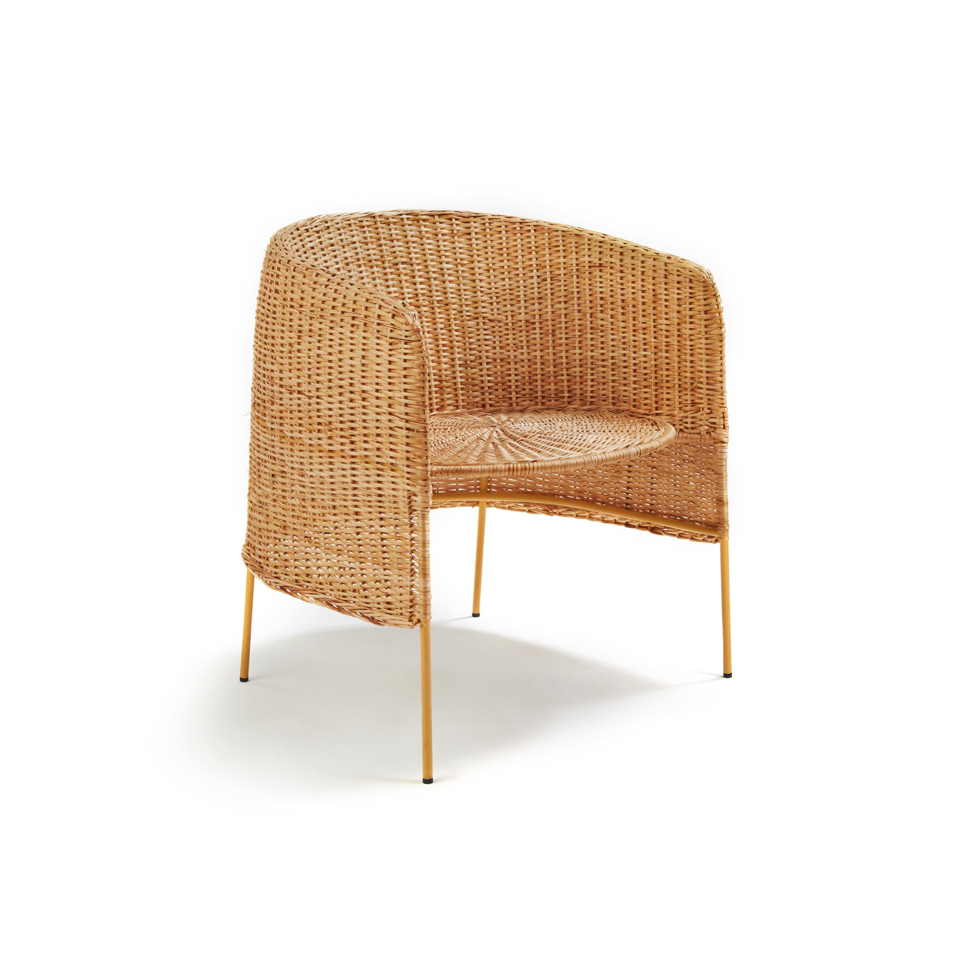 The Ames Caribe Natural Lounge Chair by Ames features a woven rattan design, rounded backrest, and slim gold metal legs, inspired by natural wicker furniture and shown against a plain white background.