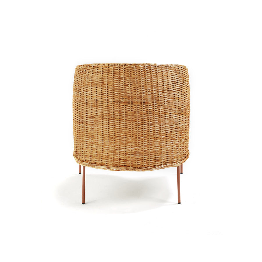 The Ames Caribe Natural Lounge Chair by Ames features a rounded backrest and slim, angled metal legs, offering a modern twist on natural wicker design—seen from behind against a plain white background and inspired by Caribbean style.