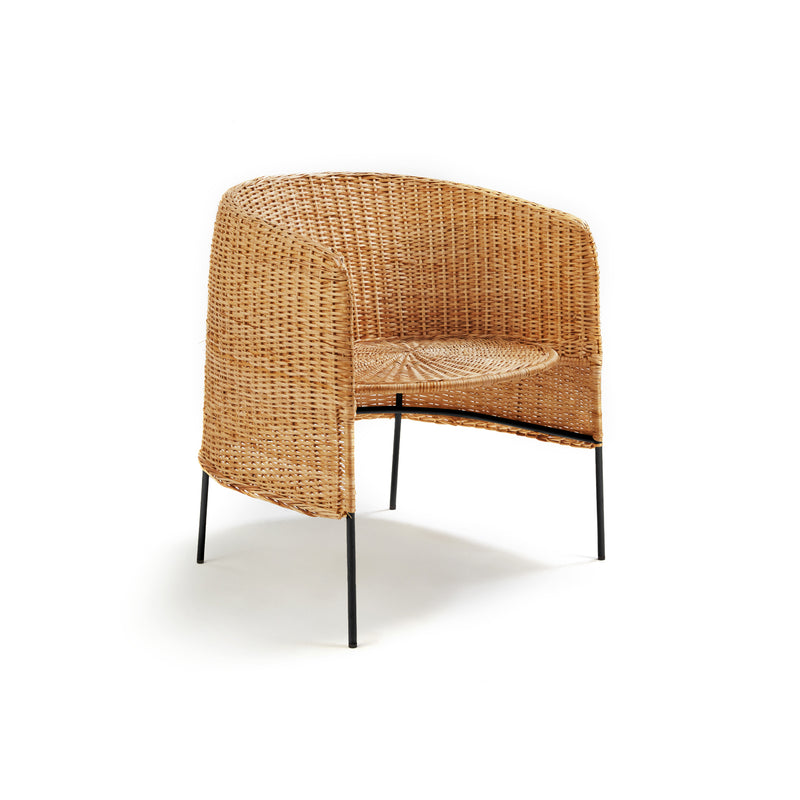 The Ames Caribe Natural Lounge Chair by Ames, inspired by natural wicker furniture, features a rounded back and black slender metal legs, shown against a plain white background.