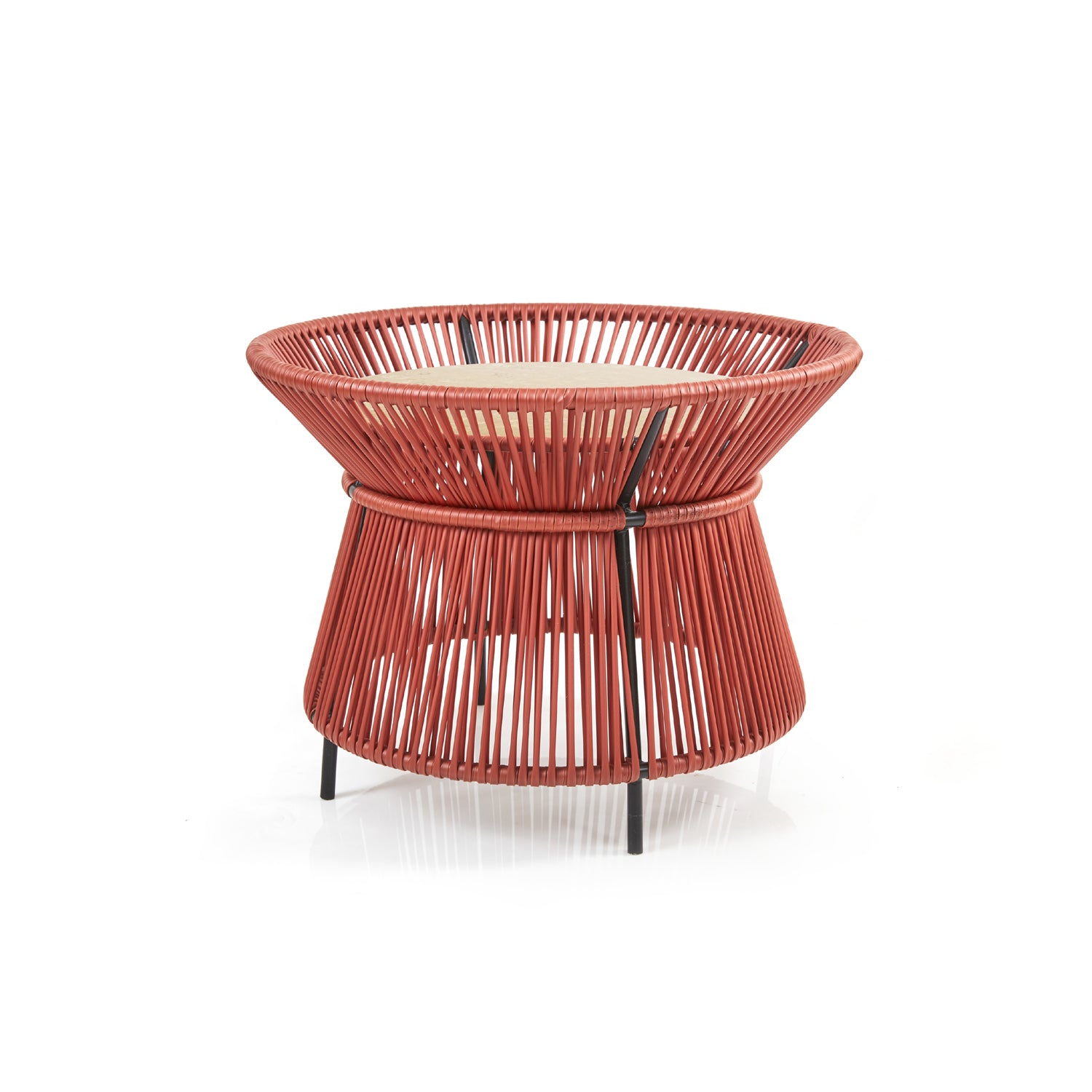 The Caribe Chic Basket Table by Ames is a modern, hourglass-shaped side table with a red woven wire frame crafted using the Momposino weaving technique and a wooden top. The tightly packed wires create a geometric pattern, making it an elegant piece in the Caribe Chic Series.