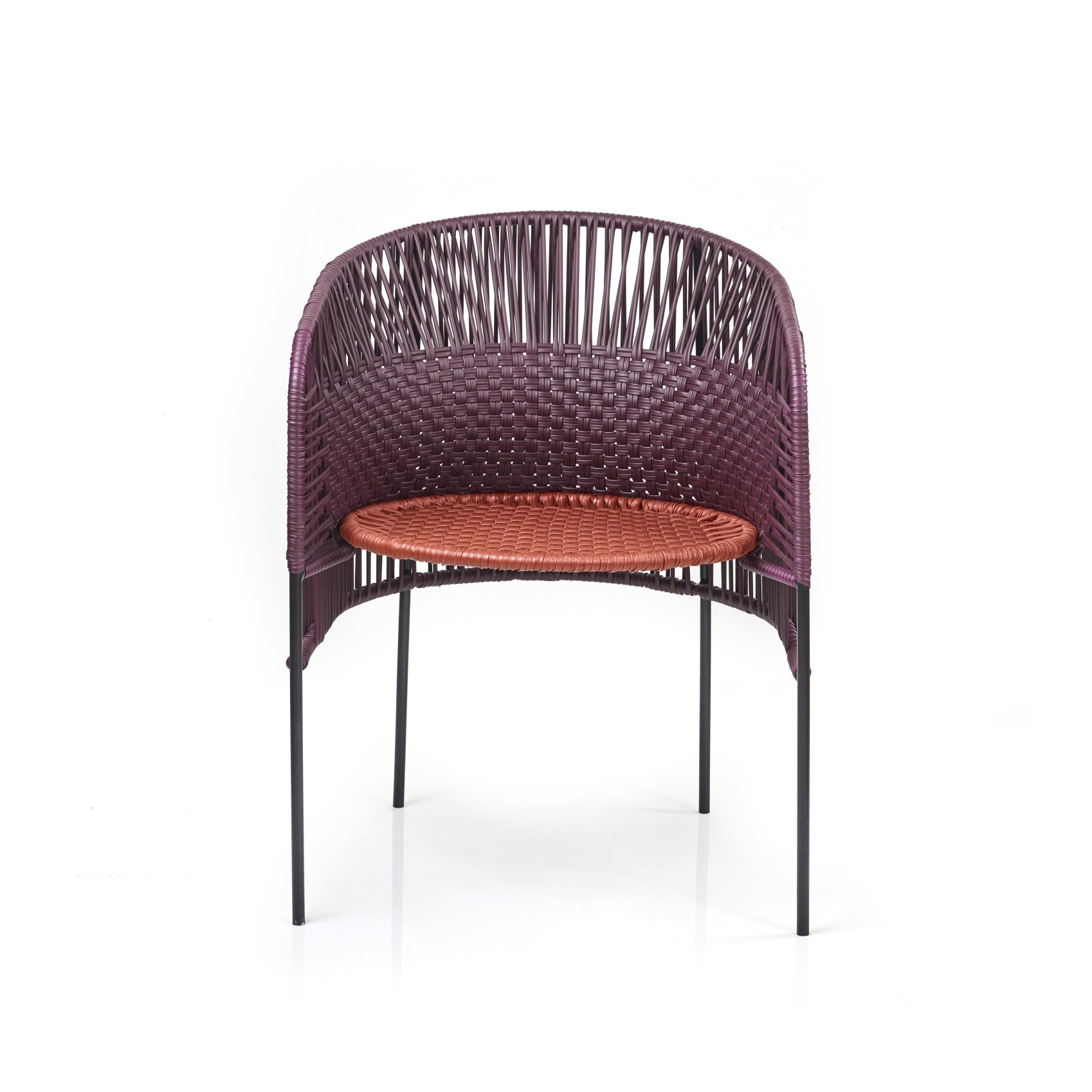 Designed by Sebastian Herkner, the Ames Caribe Chic Dining Chair features a modern design with a curved, woven back of dark purple and a bright orange seat made from recycled plastic cords. It stands on four slender black legs.