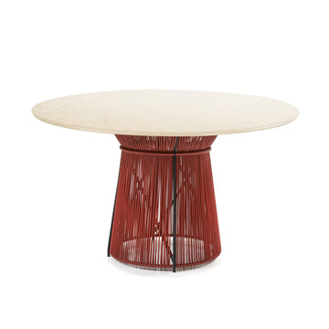 The Ames Caribe Chic Dining Table by Ames, designed by Sebastian Herkner, features a round light marble top and a red metal base with vertical rods spaced apart for an open, airy look.