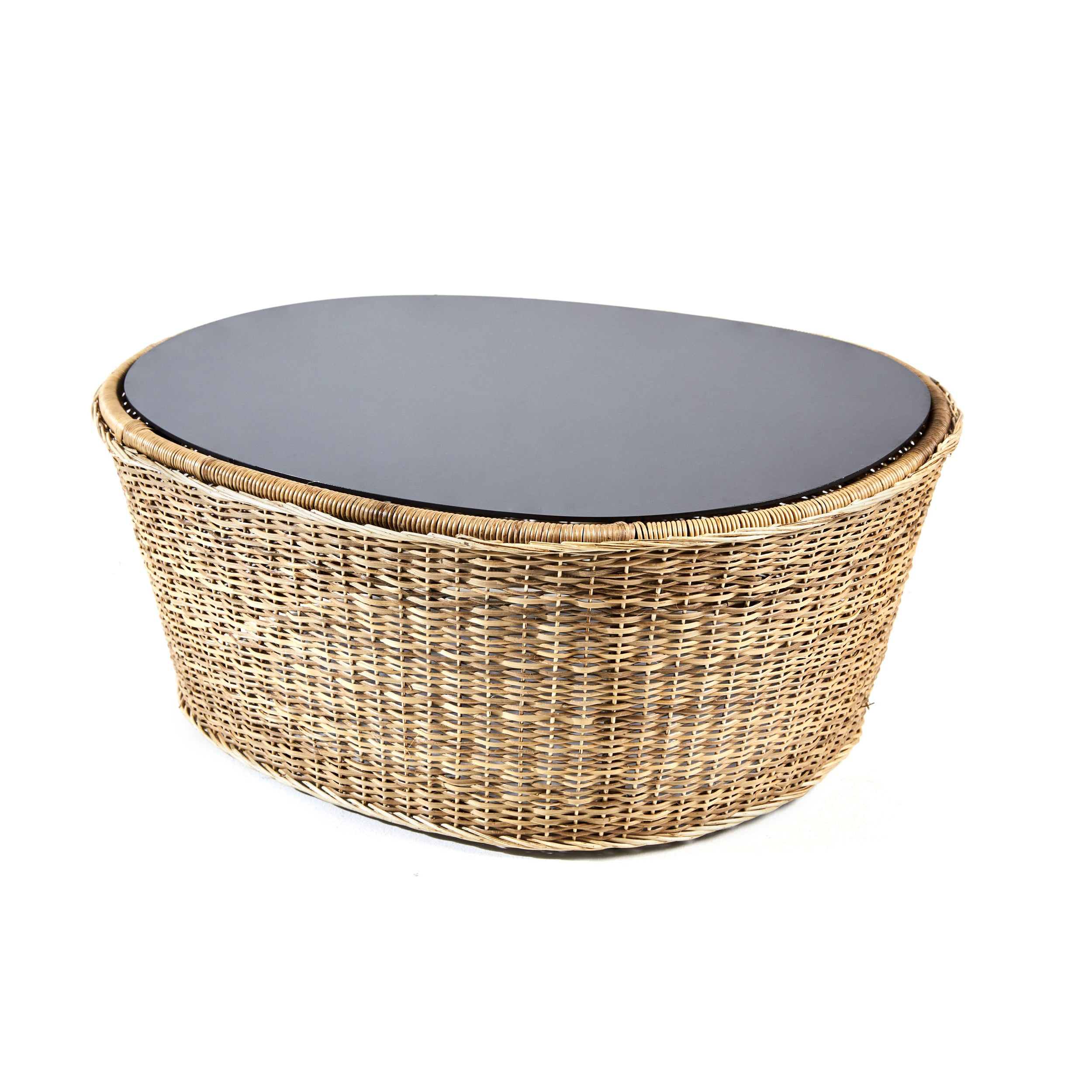 The Ames Cartagenas Natural Coffee Table by Ames features a dark smooth oval top and a woven wicker base in natural tan, inspired by Cartagenas furniture, shown against a white background.