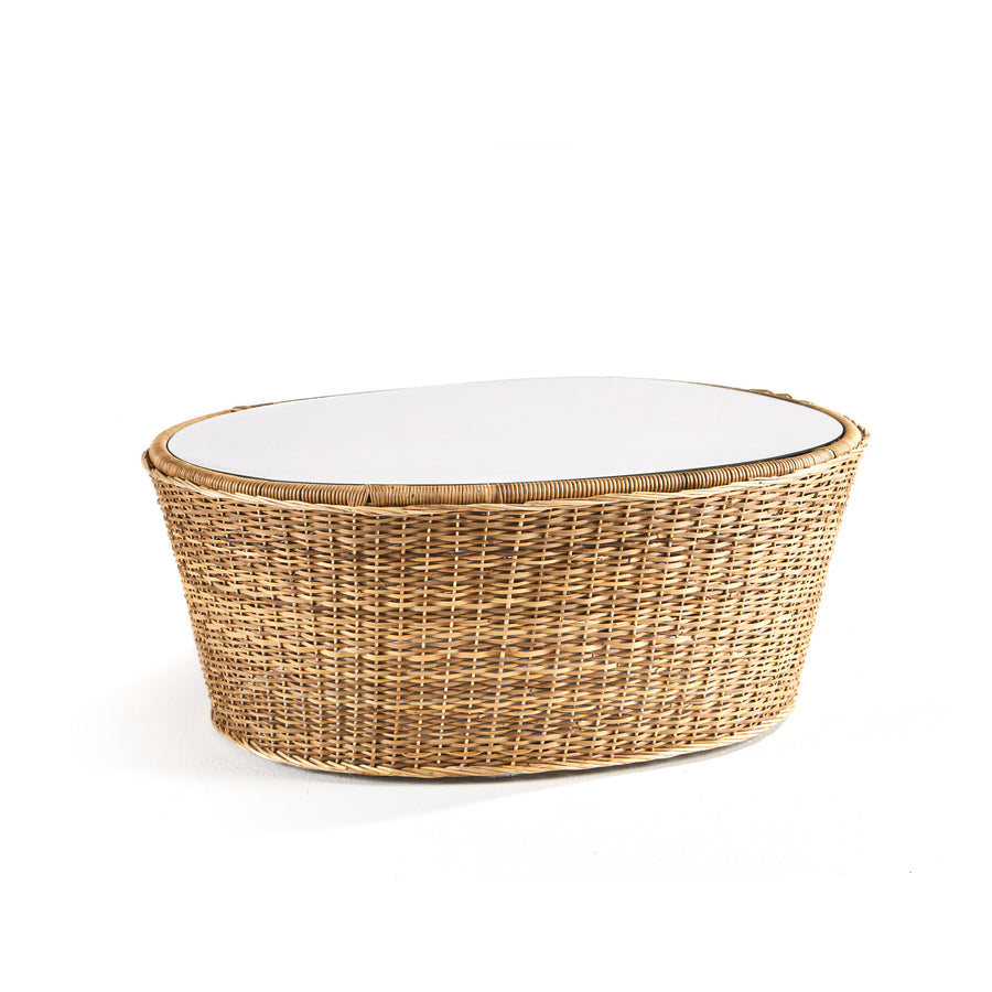 The Ames Cartagenas Natural Coffee Table by Ames features an oval white top and a woven rattan base, inspired by Cartagenas furniture, displayed against a plain white background.
