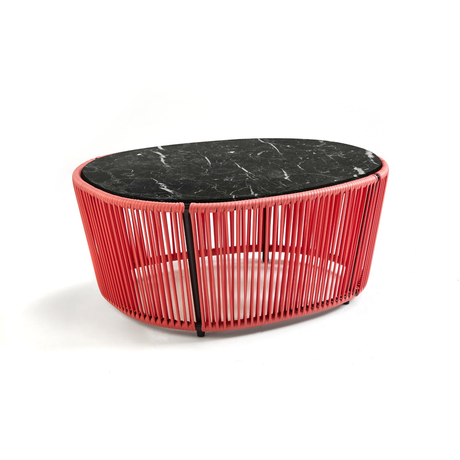 The Ames Cartagenas Coffee Table, designed by Sebastian Herkner for Ames, features an oval black marble top and a red base with vertical rods in an open circular pattern, set against a white background.