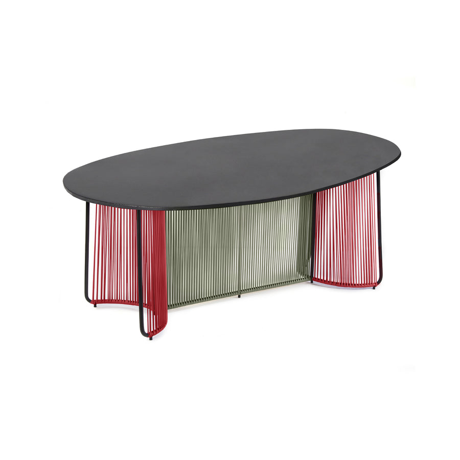 The Ames Cartagenas Dining Table by Ames features an oval black marble top and a unique base with vertical red and green rods, offering a modern, artistic look inspired by Sebastian Herkner’s design.