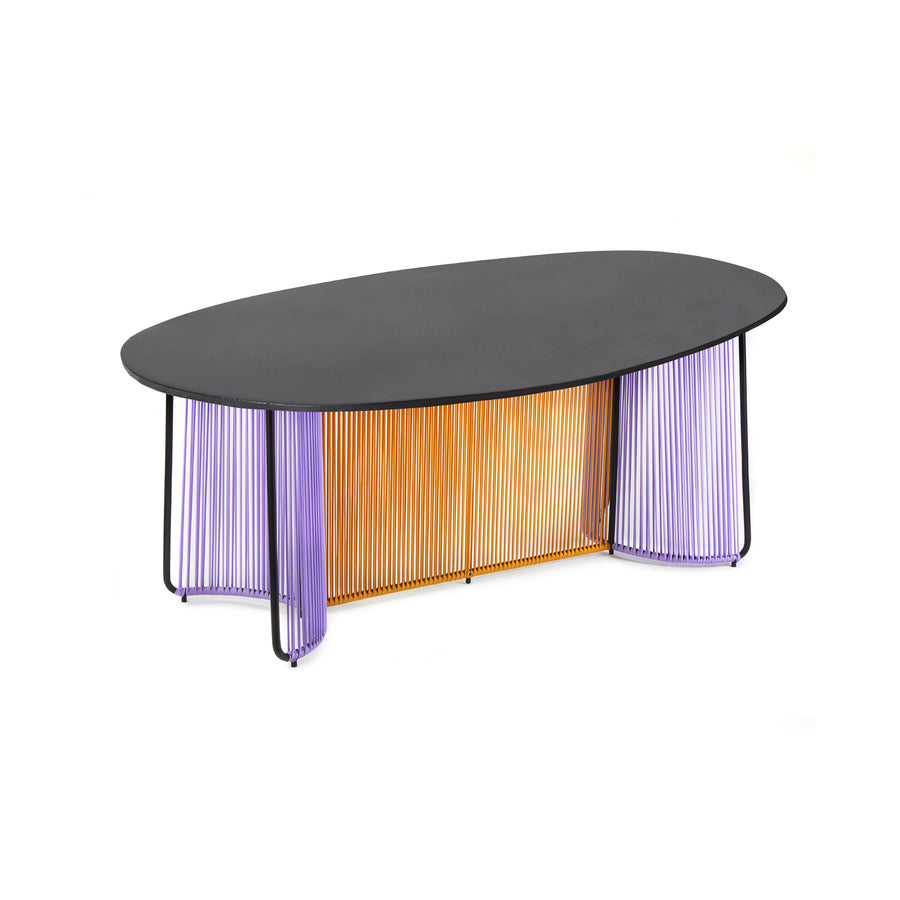 The Ames Cartagenas Dining Table by Ames features a matte black oval top and a base of vertical orange and purple rods, creating a modern, artistic look inspired by Sebastian Herkner’s design.