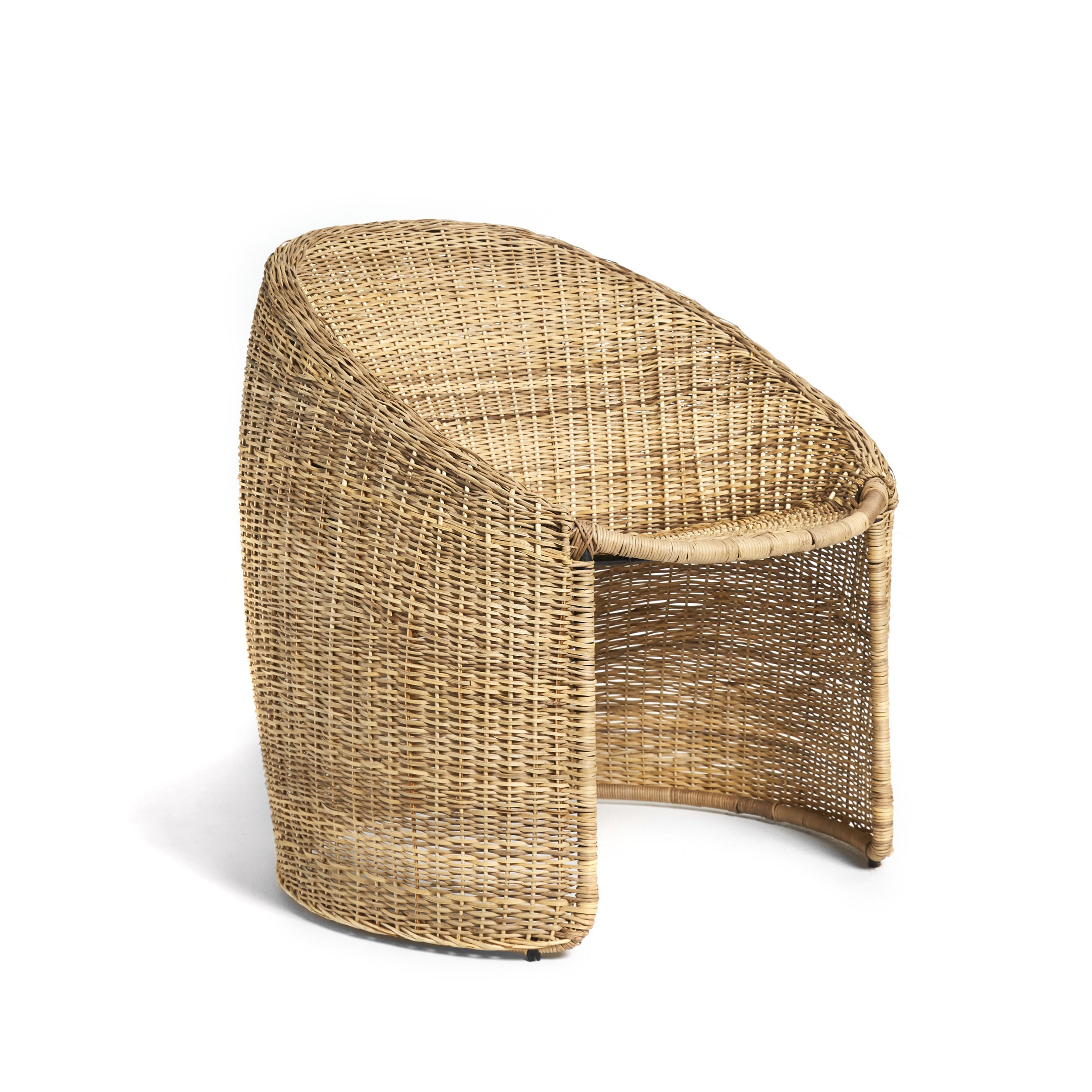 The Ames Cartagenas Natural Lounge Chair, designed by Sebastian Herkner, features a curved backrest and open sides. Its cone-like shape and natural light brown color elegantly stand against a plain white background.