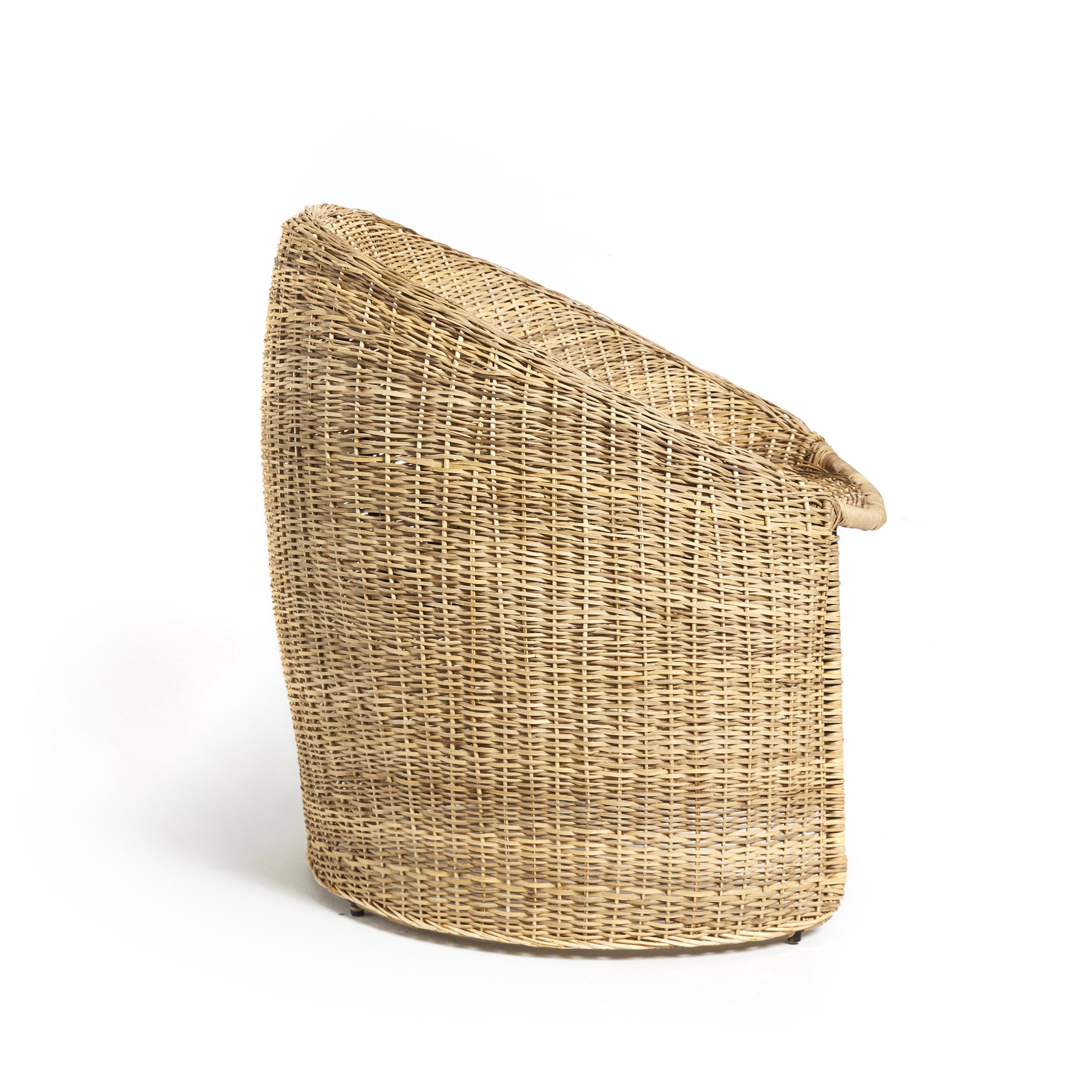 The Cartagenas Natural Lounge Chair by Ames is a woven wicker chair with a high back and rounded design in the style of Sebastian Herkner, featuring a neutral beige color. It is shown empty against a white background.