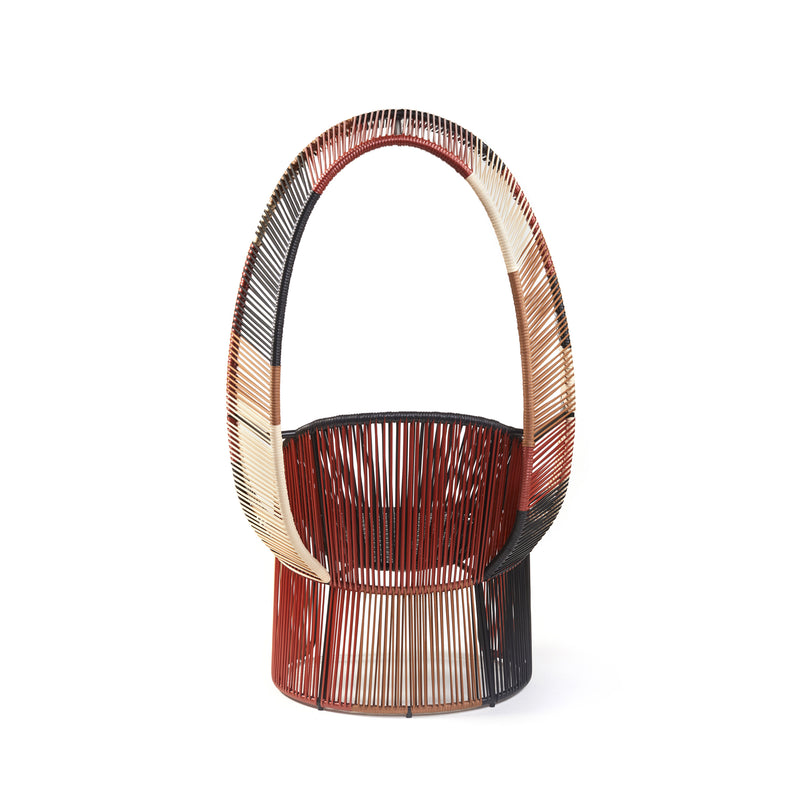 Introducing the Cartagenas Reina Chair Limited Edition by Ames, a modern masterpiece with an arched backrest in woven shades of red, cream, and black. Its circular base and airy structure add artistic flair to any outdoor space.