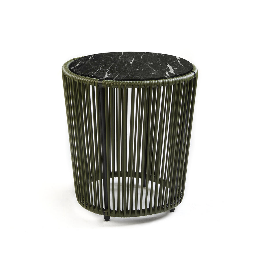 The Cartagenas Sidetable by Ames features a black marble top and a cylindrical base of vertical green metal bars, embodying a modern, minimalist design. Inspired by the vibrant coastal city, this piece reflects Sebastian Herkners visionary style against a simple white backdrop.