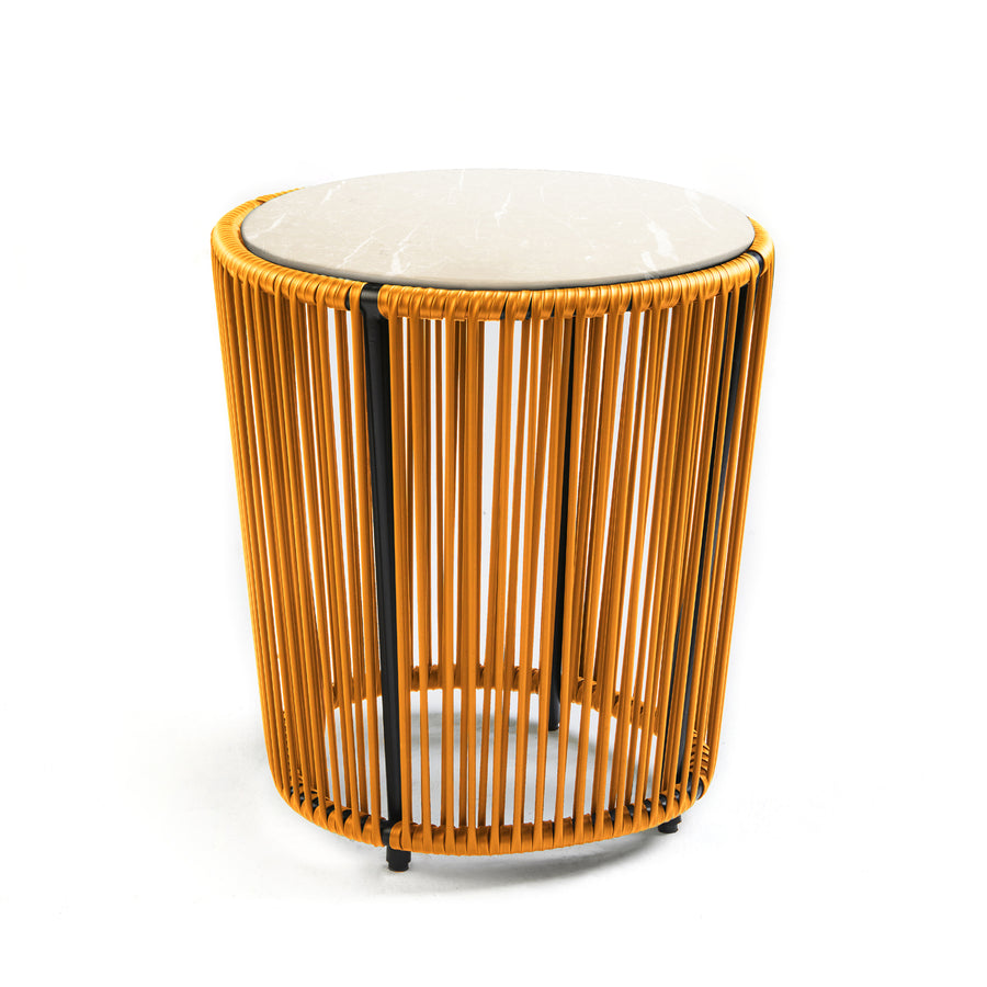 The Cartagenas Sidetable by Ames, designed by Sebastian Herkner, features a round white marble top and a base of golden rods, combining solid elegance with an airy coastal vibe.