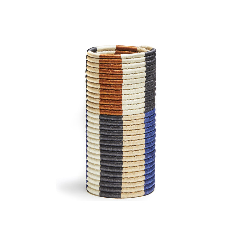Part of the Choco Vases collection by Ames, this cylindrical woven basket showcases elegant horizontal stripes in black, blue, brown, beige, and white. Made from palm fibers for a natural touch and exquisite design, its perfect for any space.