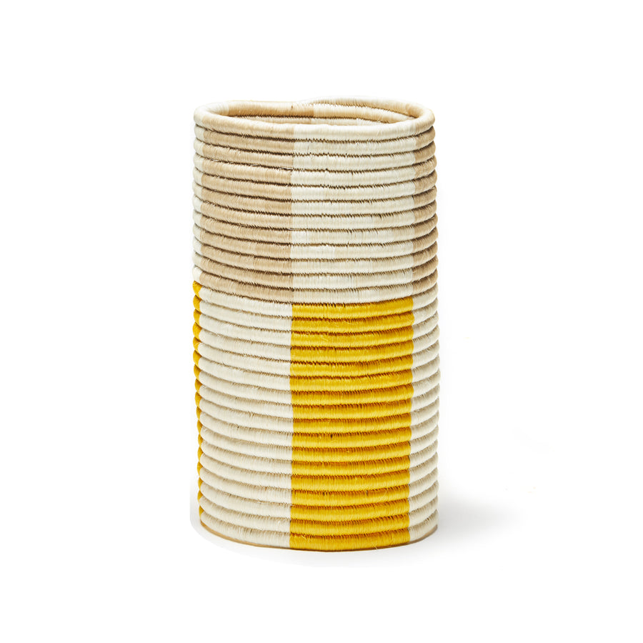 From the Ames Choco Vases collection, this cylindrical vase features horizontal rows of palm fibers in beige, white, and yellow, creating a neatly textured and evenly spaced striped pattern.