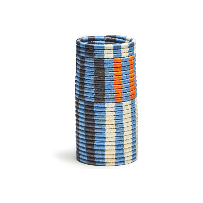 From the Choco Vases collection by Ames, this cylindrical basket features horizontal stripes in blue, black, white, and orange. Made from palm fibers, it boasts a woven texture that brings modern artistic flair to any space.