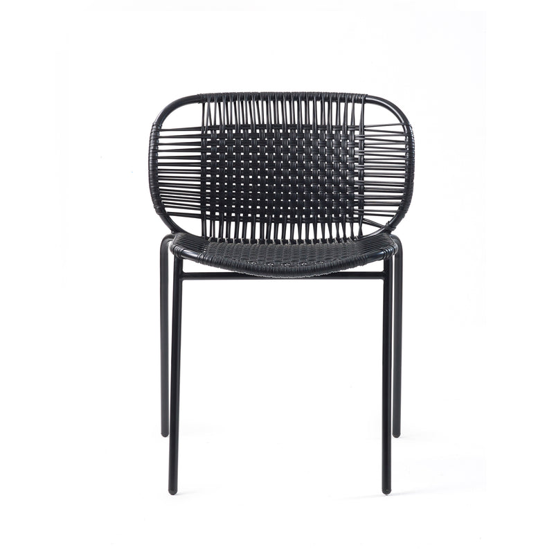 The Ames Cielo Chair by Ames features a modern, stackable design with a woven black rattan seat and backrest on slim black metal legs, perfect for outdoor dining. Shown against a plain white background.