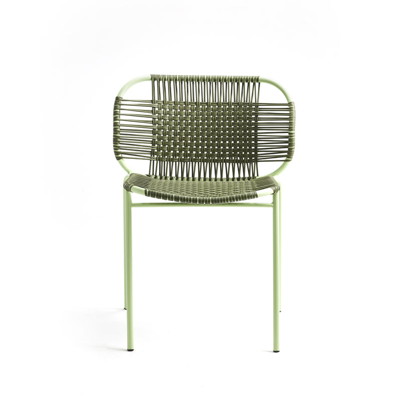 The Ames Cielo Chair by Ames is a green metal outdoor dining chair with a woven backrest and seat, featuring thin legs and a minimalist, airy design. This stackable chair is shown against a plain white background.