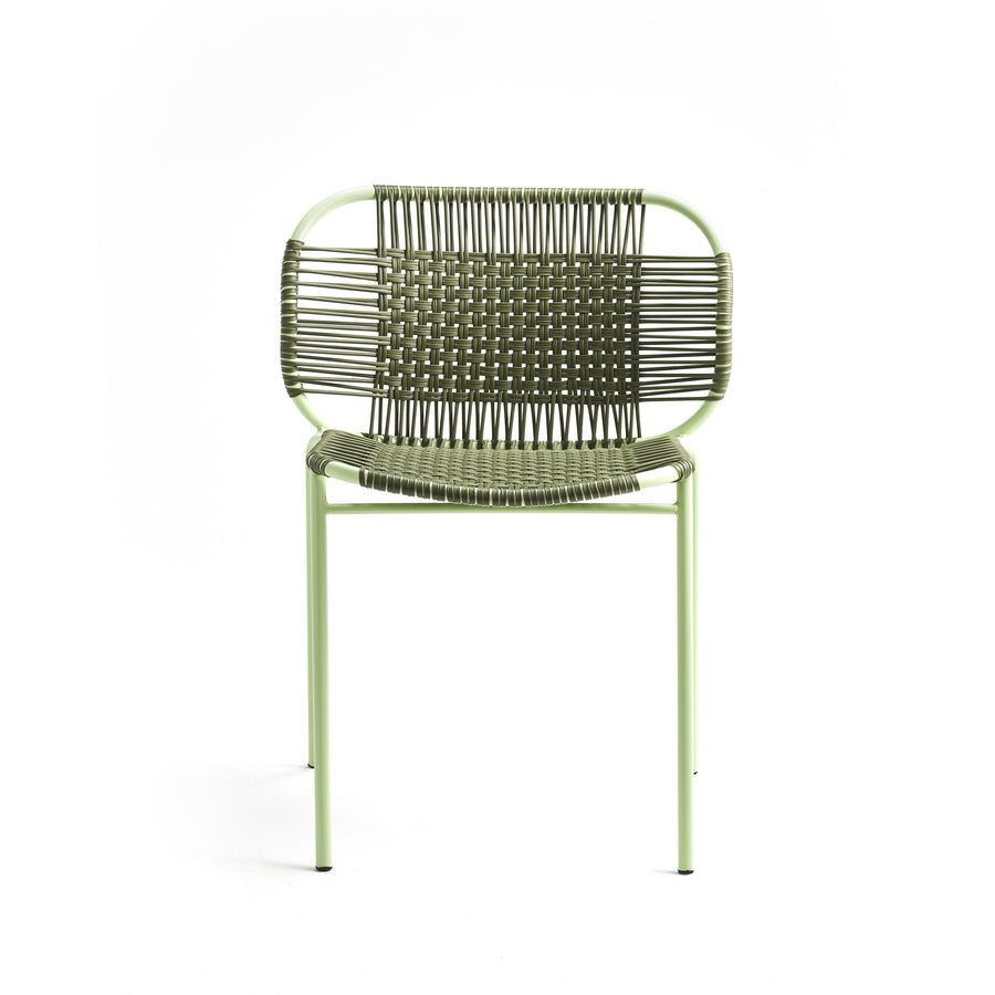 The Ames Cielo Chair by Ames is a green metal outdoor dining chair with a woven backrest and seat, featuring thin legs and a minimalist, airy design. This stackable chair is shown against a plain white background.