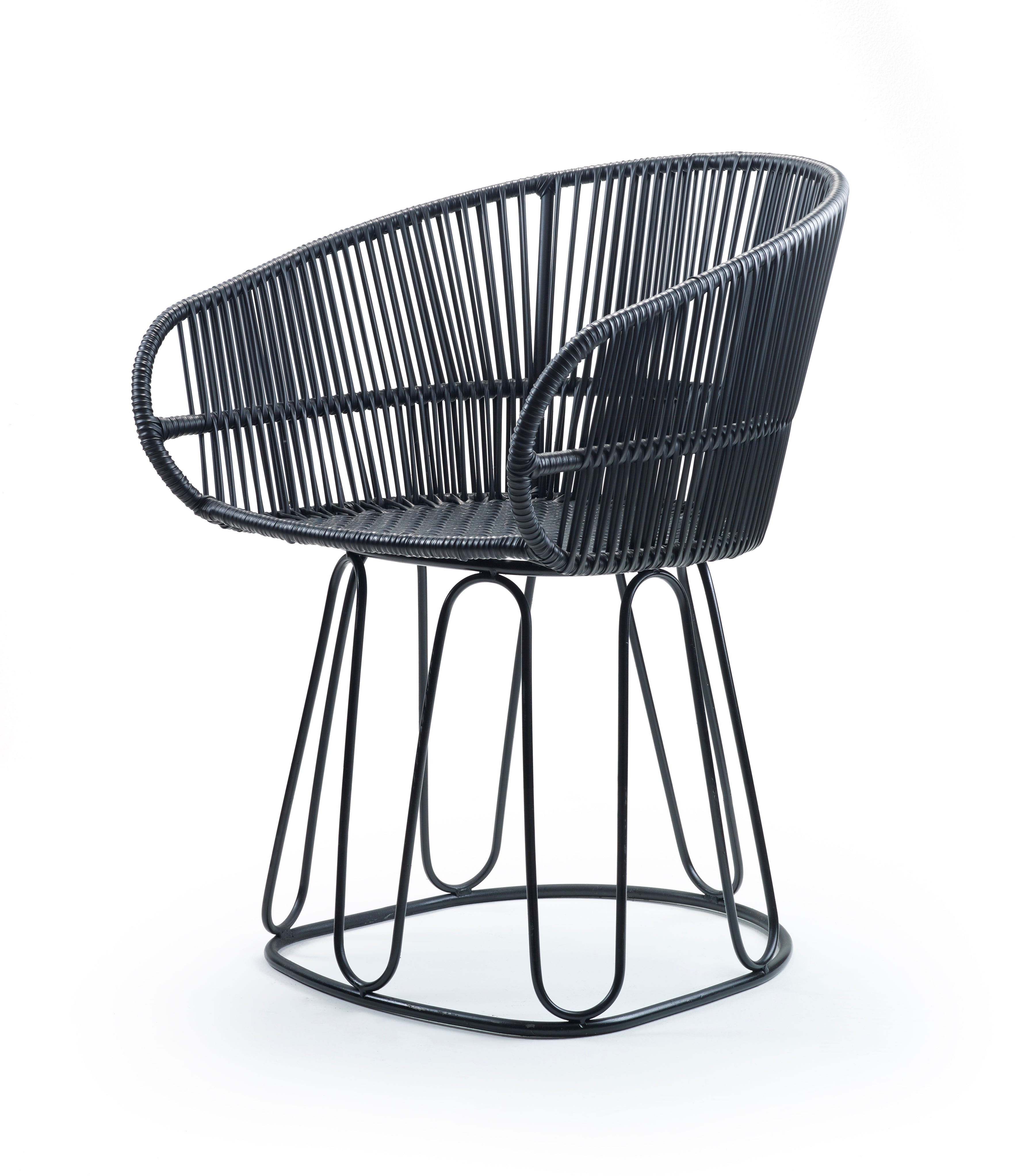 The Ames Circo Chairs - Sale boasts a rounded, open-weave rattan design with metal legs and a curved backrest. Handcrafted by Colombian artisans, this modern black chair offers a sleek, minimalist style for a contemporary look.