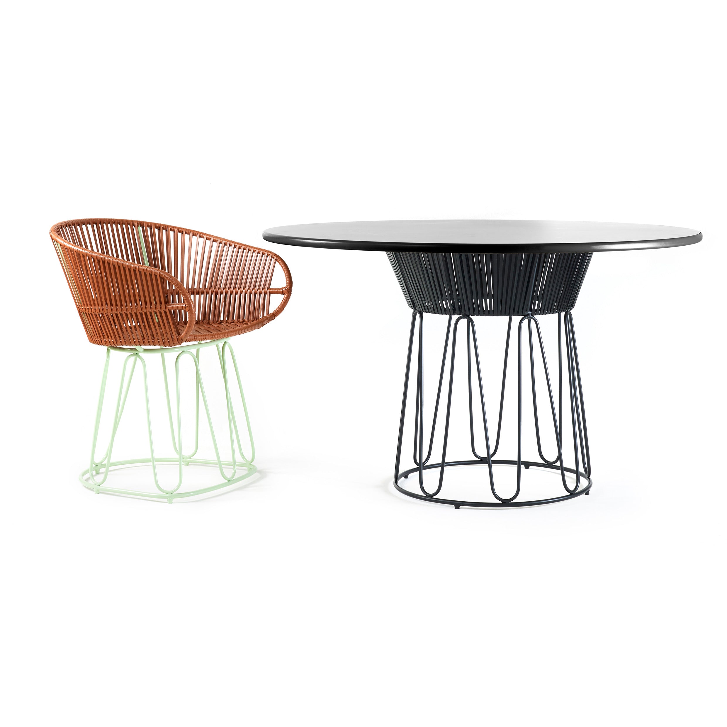 Explore Ames Circo Leather Dining Table—a modern patio set with a monochromatic tabletop and sleek wireframe base. It includes a matching chair with a brown woven seat and mint green wireframe legs, creating a contemporary and minimalist ensemble.