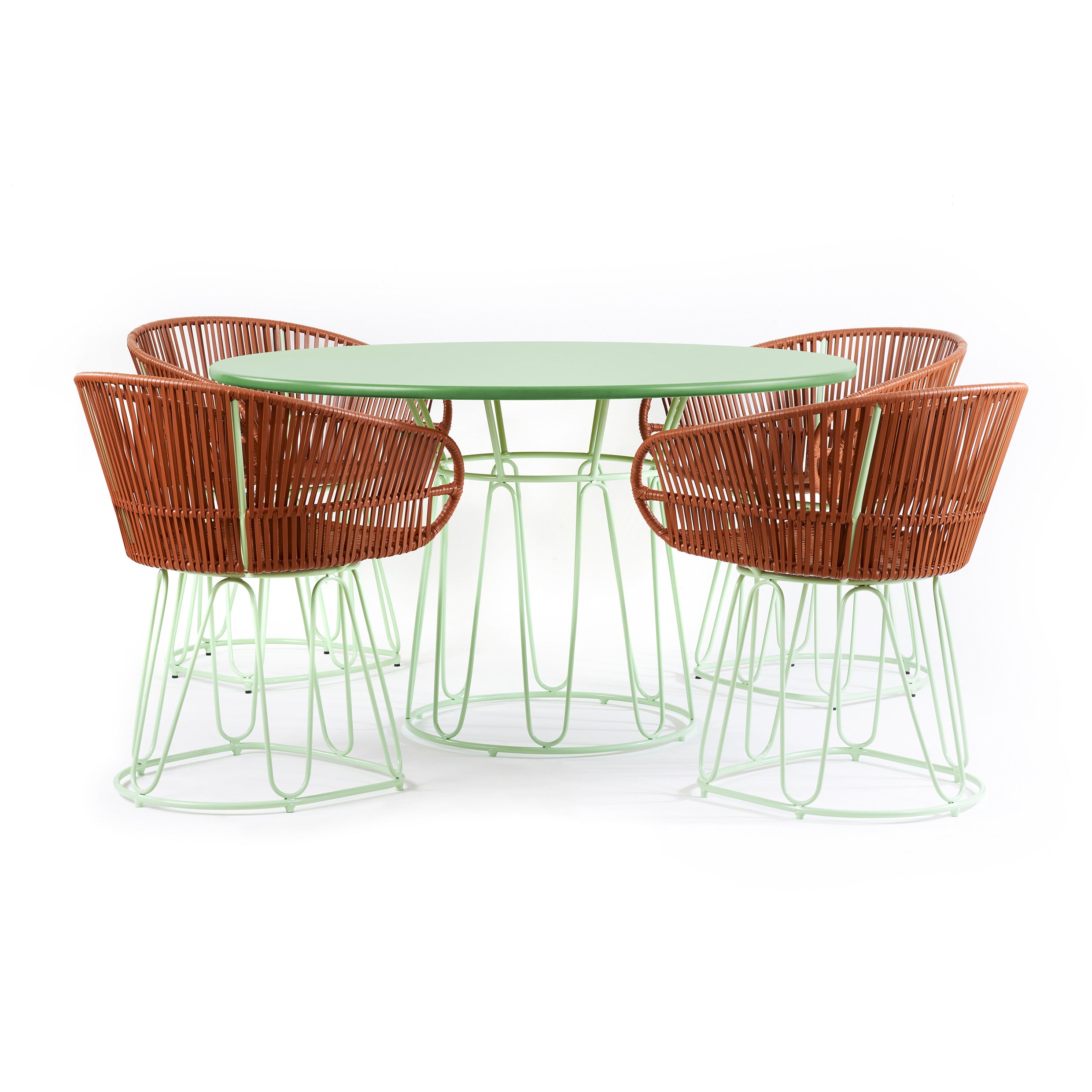 The Ames Circo Dining Table by Ames is shown with four green chairs featuring brown woven backs, braided leather cords, and pale green metal frames, all arranged for indoor use against a white background.