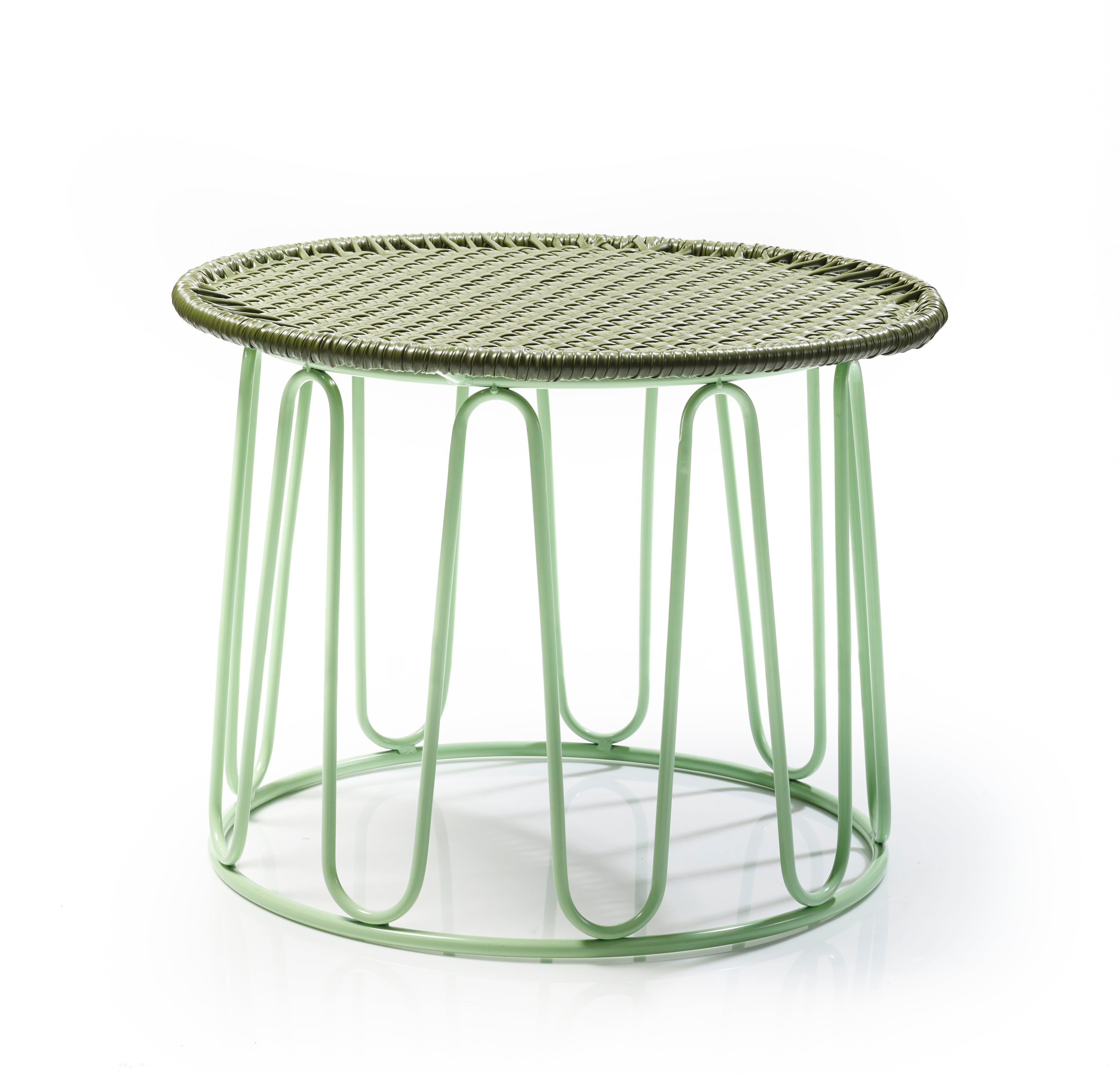 The Ames Circo Side Table by Ames, designed by Sebastian Herkner, features a woven top and light green wire frame—a handcrafted Colombian piece shown against a white background.