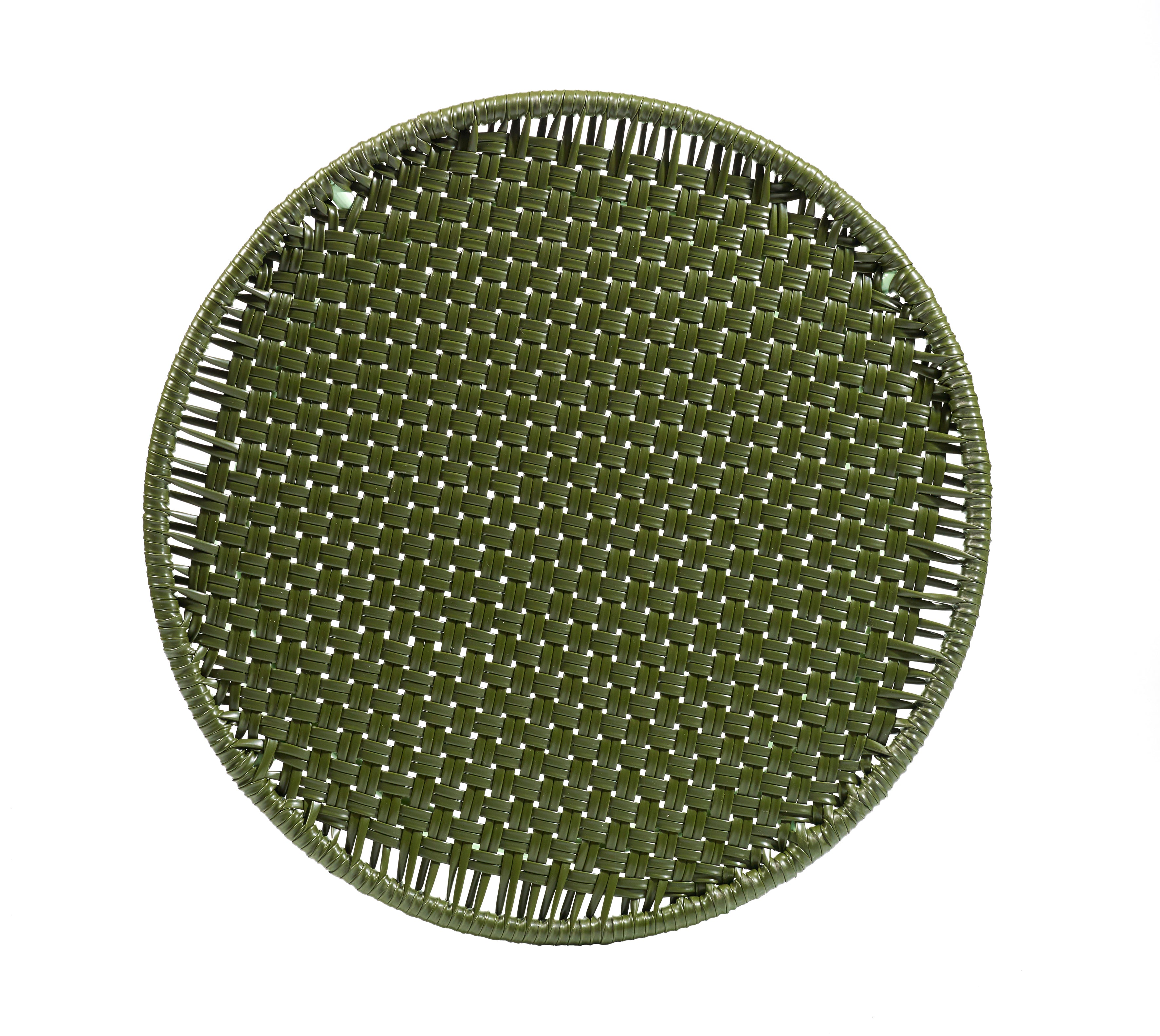 An Ames Circo Side Table from the brand Ames, designed by Sebastian Herkner, is displayed from above against a white background. The table features a round, green woven wicker design inspired by traditional Colombian craftsmanship.