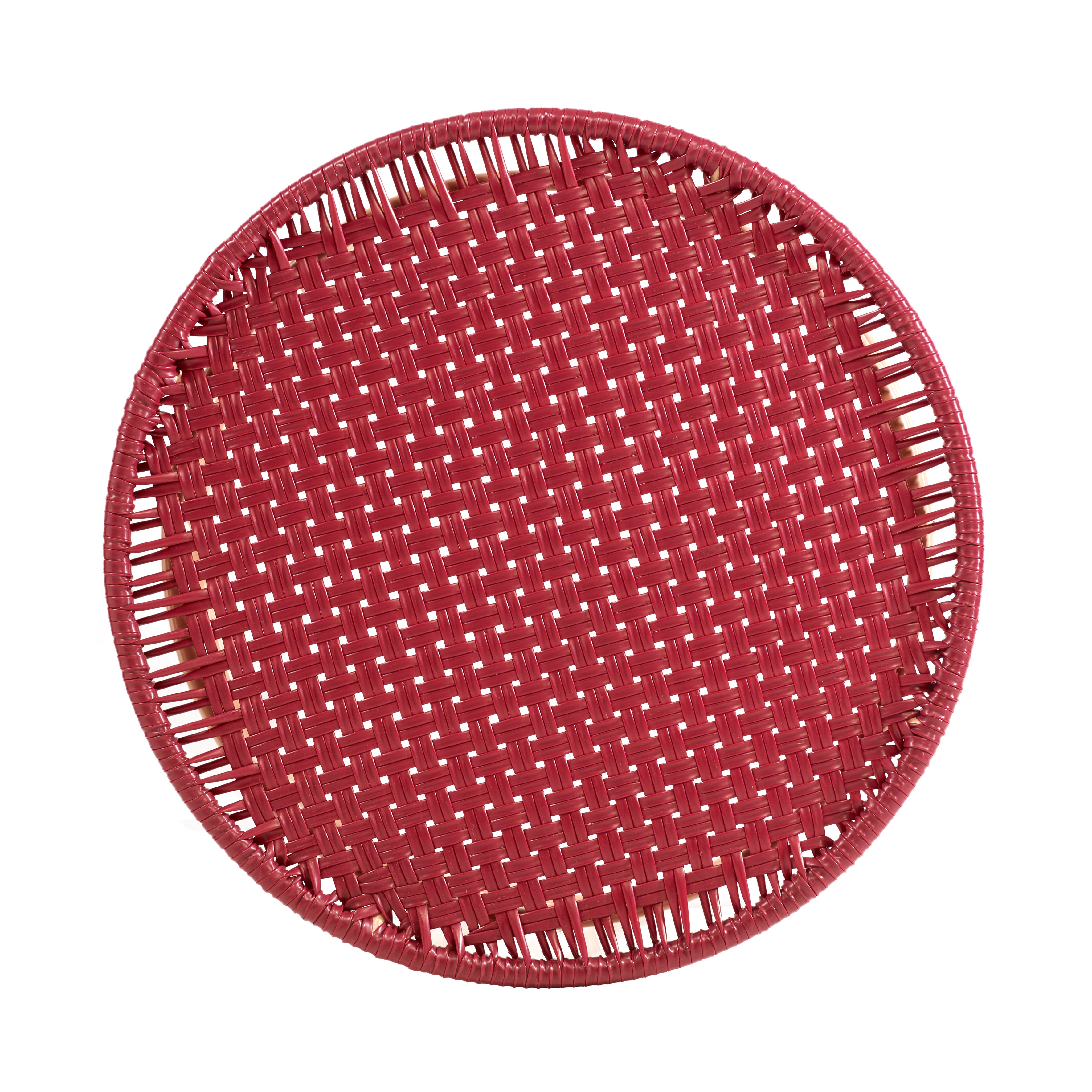 A round, flat, red side table from the Ames Circo collection by Ames, showcasing a basket-like weave inspired by handcrafted Colombian furniture, seen from above on a white background.