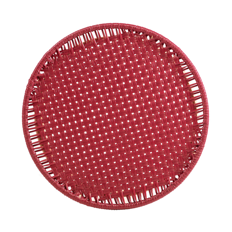 A round, flat, red side table from the Ames Circo collection by Ames, showcasing a basket-like weave inspired by handcrafted Colombian furniture, seen from above on a white background.