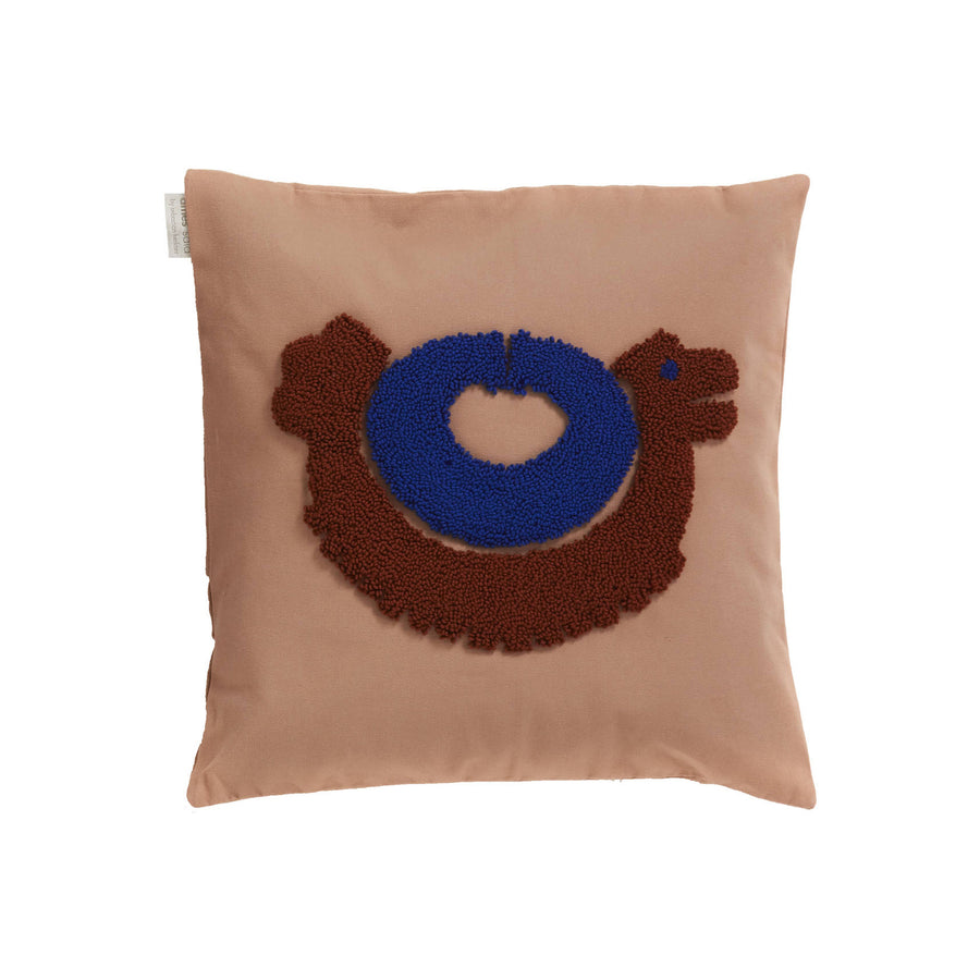 The Ames Nido Pichu cushion by Ames is a square beige pillow with an abstract embroidered brown chicken, blue circular body, and a small white heart at the center.