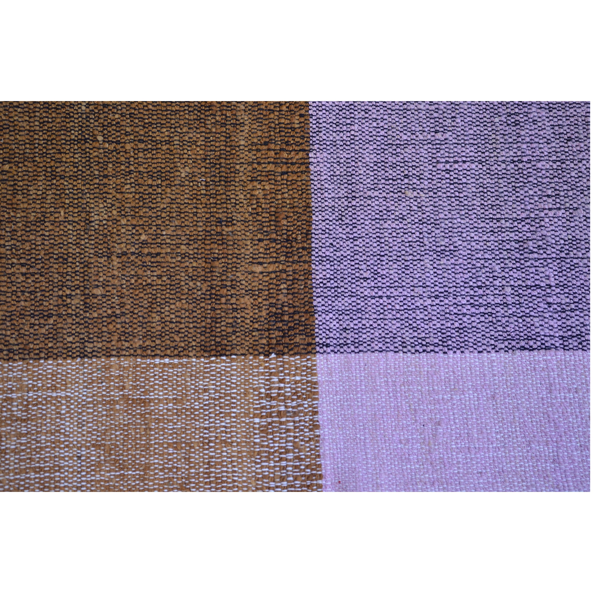 Ames Nobsa Rug showcases a close-up of a checkerboard pattern, featuring alternating brown and purple squares. This hand-woven textile highlights the textured weave typical of the wool artistry from Colombias Nobsa city.