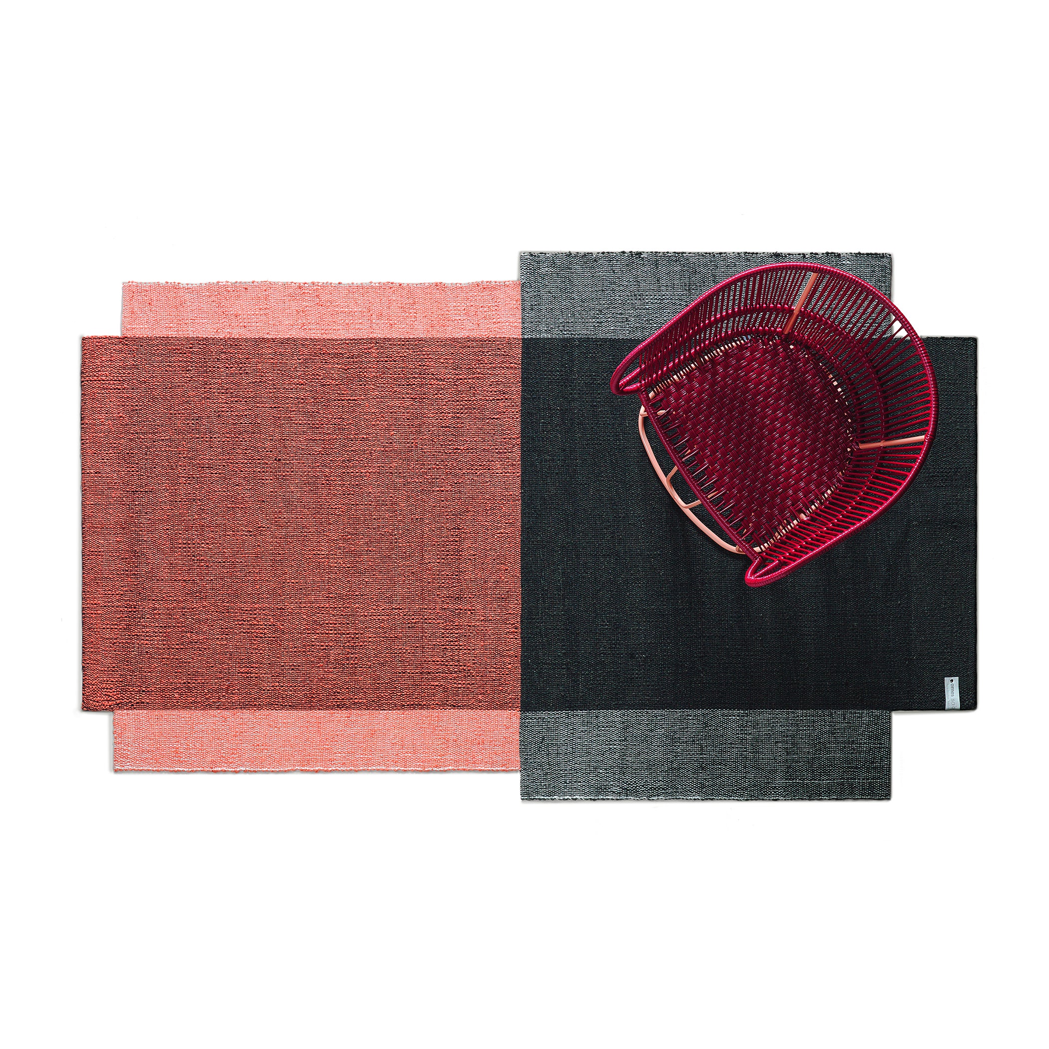 A top view shows two overlapping rectangular rugs, one red and one black. A hand-woven wool Nobsa Rug by Ames from Nobsa is showcased, complemented by a red woven chair with a wave pattern on the black rug, crafting a modern geometric look.