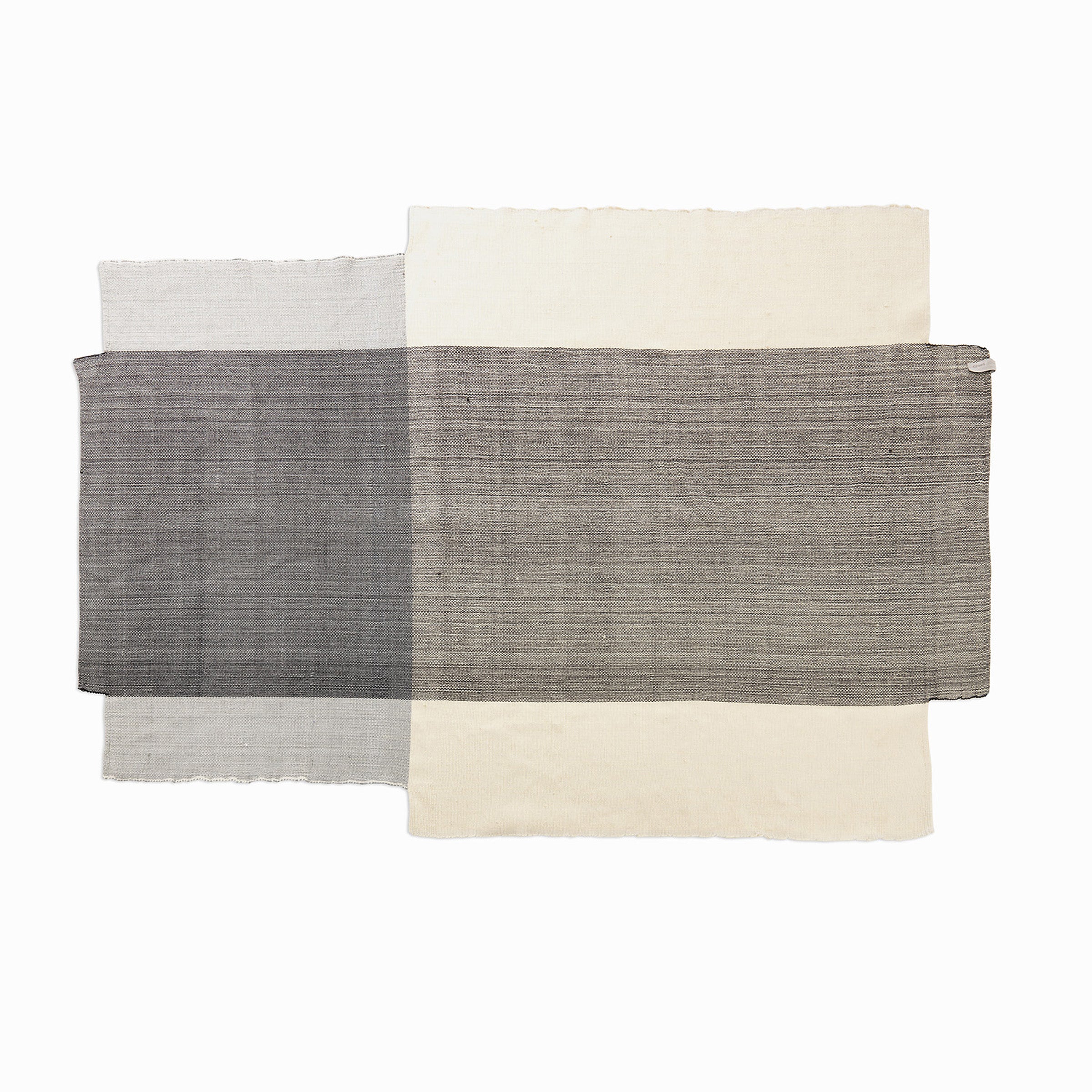 The Nobsa Rug by Ames is a minimalist textile featuring overlapping rectangles in gray, black, and beige, echoing the layered grid patterns of traditional rugs from Nobsa, Colombia. This exquisite piece is hand-woven from fine wool on a white background.