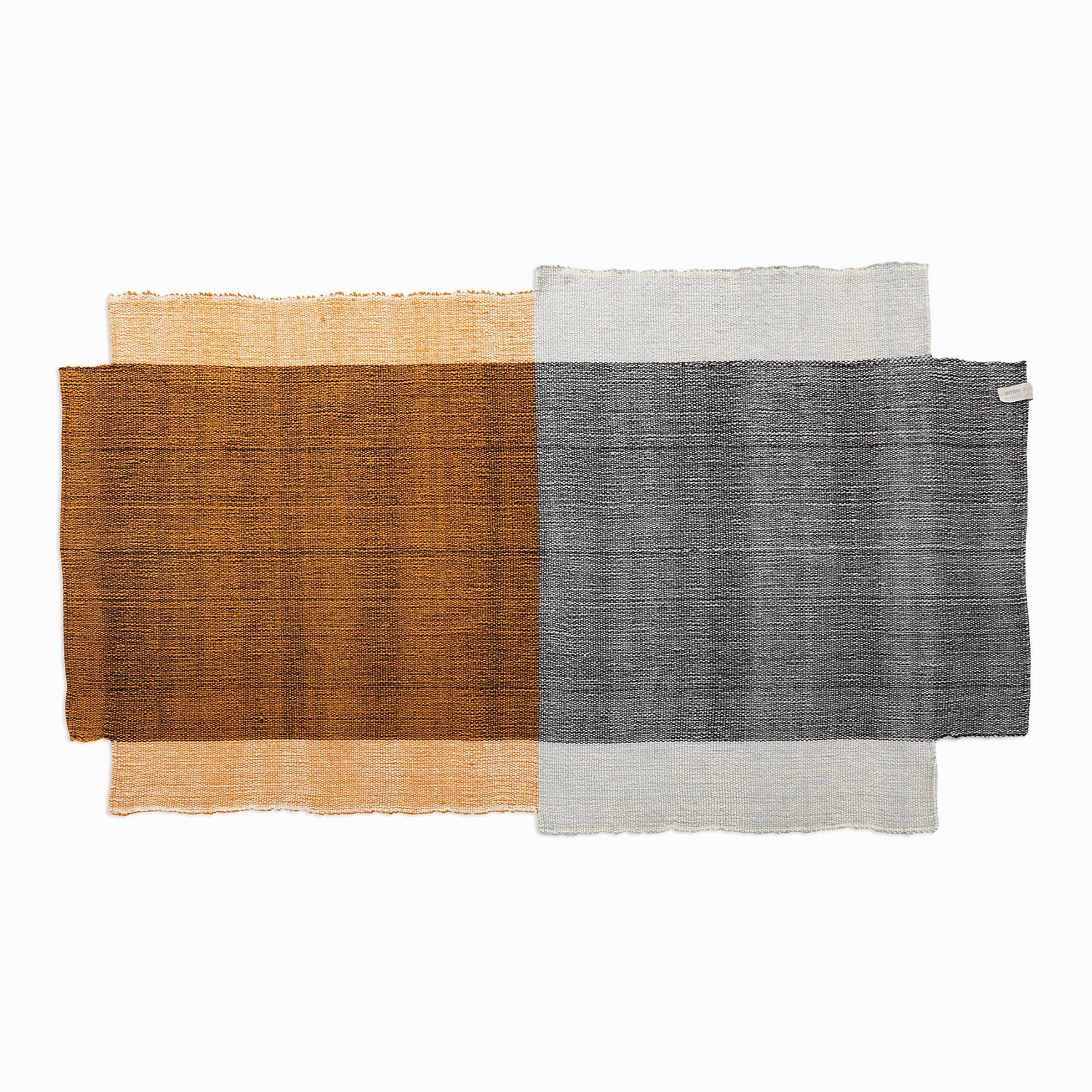 This rectangular fabric swatch has a brown and orange gradient section and a gray with light blue section, reminiscent of Nobsa rugs by Ames. The textured woven appearance mimics the artisanal charm of hand-woven wool traditions from Nobsa, Colombia.