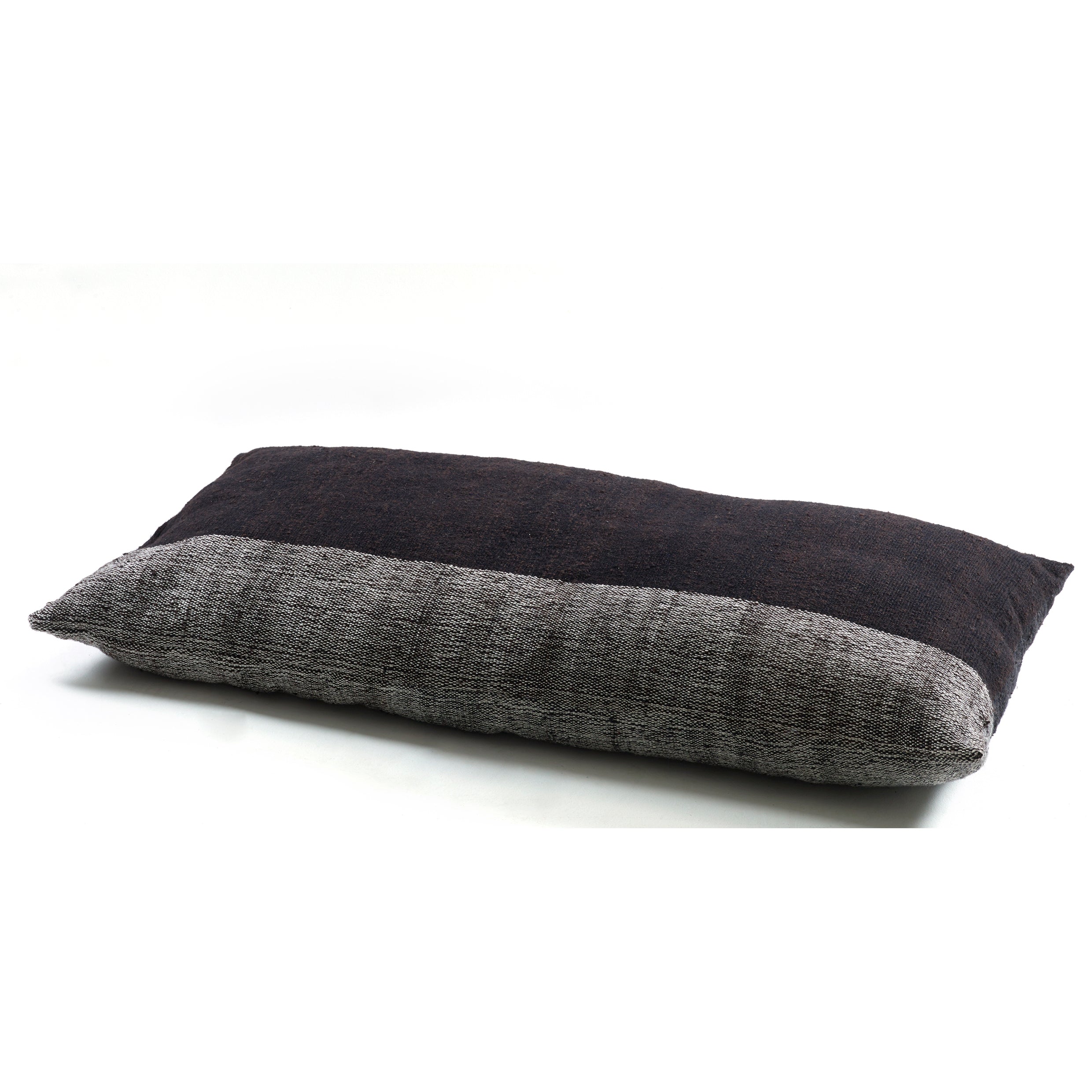 The Ames Nobsa Cushion by Ames, designed by Sebastian Herkner, is a hand-woven rectangular wool pillow with a two-tone dark and light gray design, displayed on a white background. Adds modern elegance to any space.