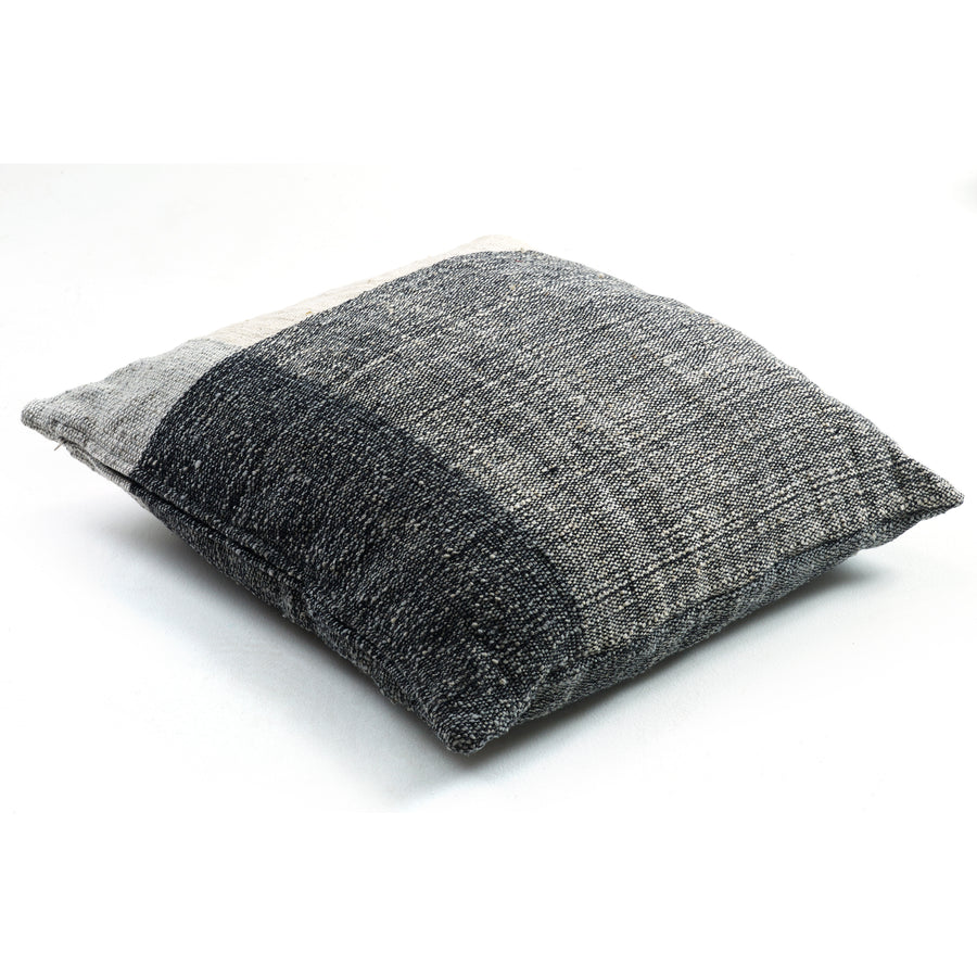 The Ames Nobsa Cushion by Ames is a square throw pillow, hand-woven from wool in gray tones and inspired by Nobsa pillows and Sebastian Herkner’s designs, shown on a white background.