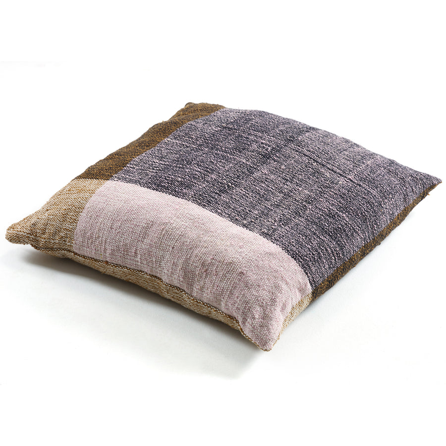 The Ames Nobsa Cushion by Ames features a square patchwork design in brown, tan, lavender, and gray, inspired by hand-woven wool and Nobsa pillows, shown on a white background.