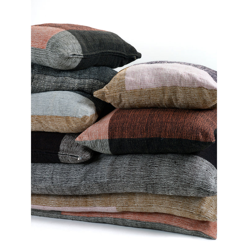 A stack of five Ames Nobsa Cushions by Ames, crafted from hand-woven wool in gray, black, brown, and muted pink, are arranged against a plain white background.