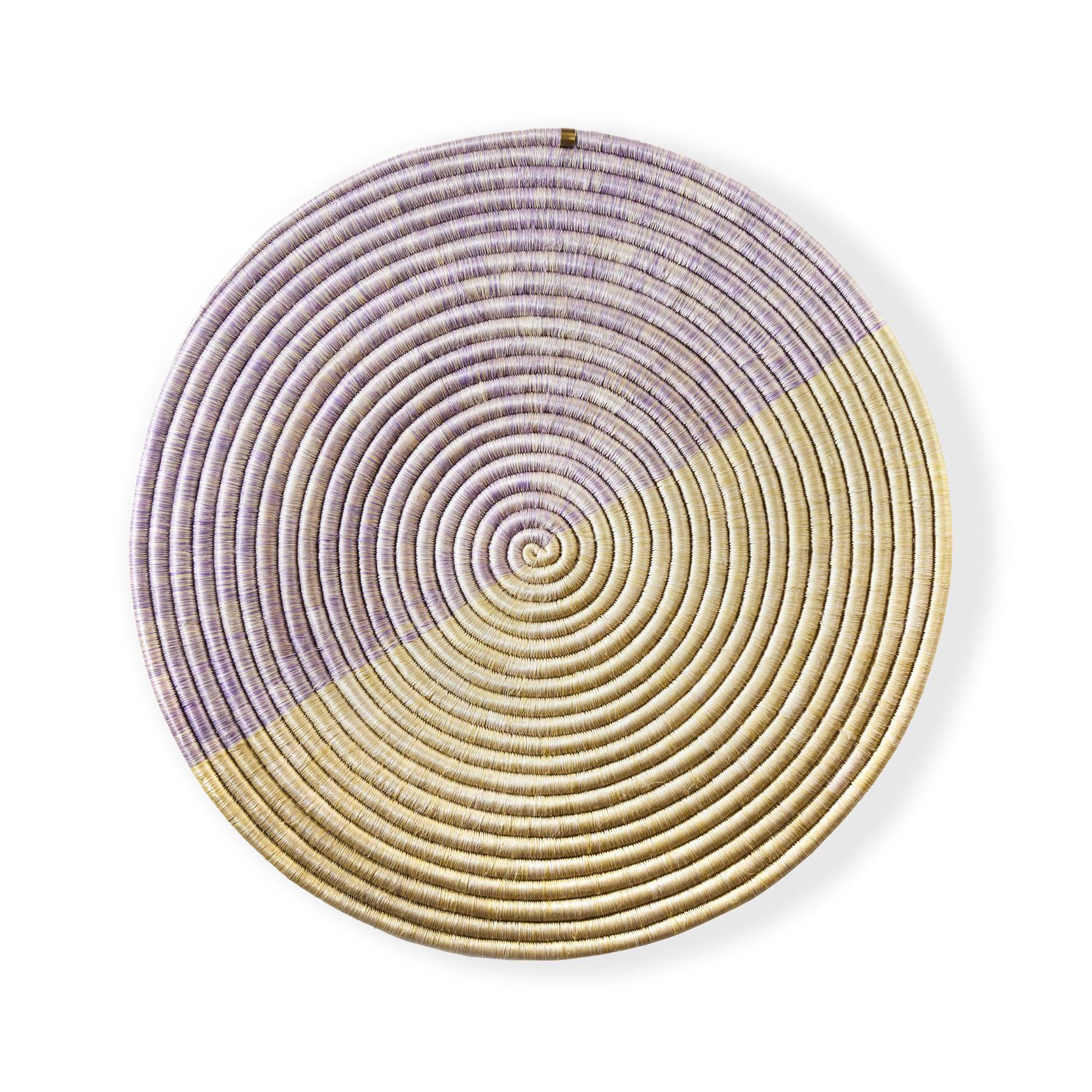 The Ames Ojitos Wall Decoration Andes by Ames is a round, woven basket wall decor crafted from fique palm fibers with a spiral pattern. Half is light tan, the other half muted lavender, offering subtle geometric contrast for any space.