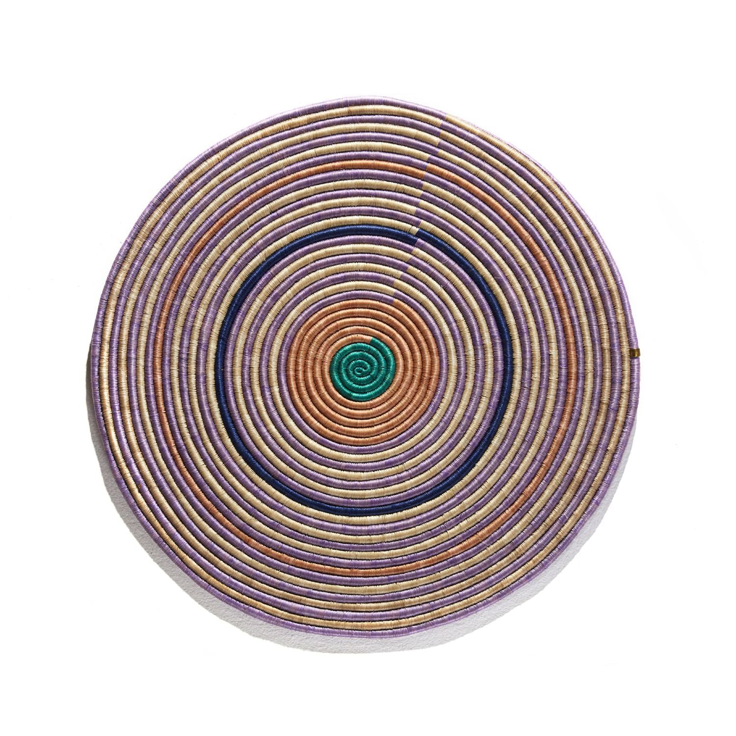 The Ames Ojitos Wall Decoration Andes by Ames is a handcrafted, coiled fique palm fiber accent featuring spiraling beige, purple, orange, and green rings—vibrantly inspired by traditional wall decor.