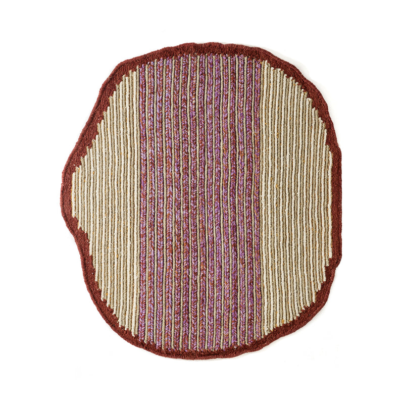 The Ames Uilas Rug by Ames is round with an irregular shape, a red border, and vertical stripes in beige, red, and purple for a textured, woven look inspired by handmade wool rugs.