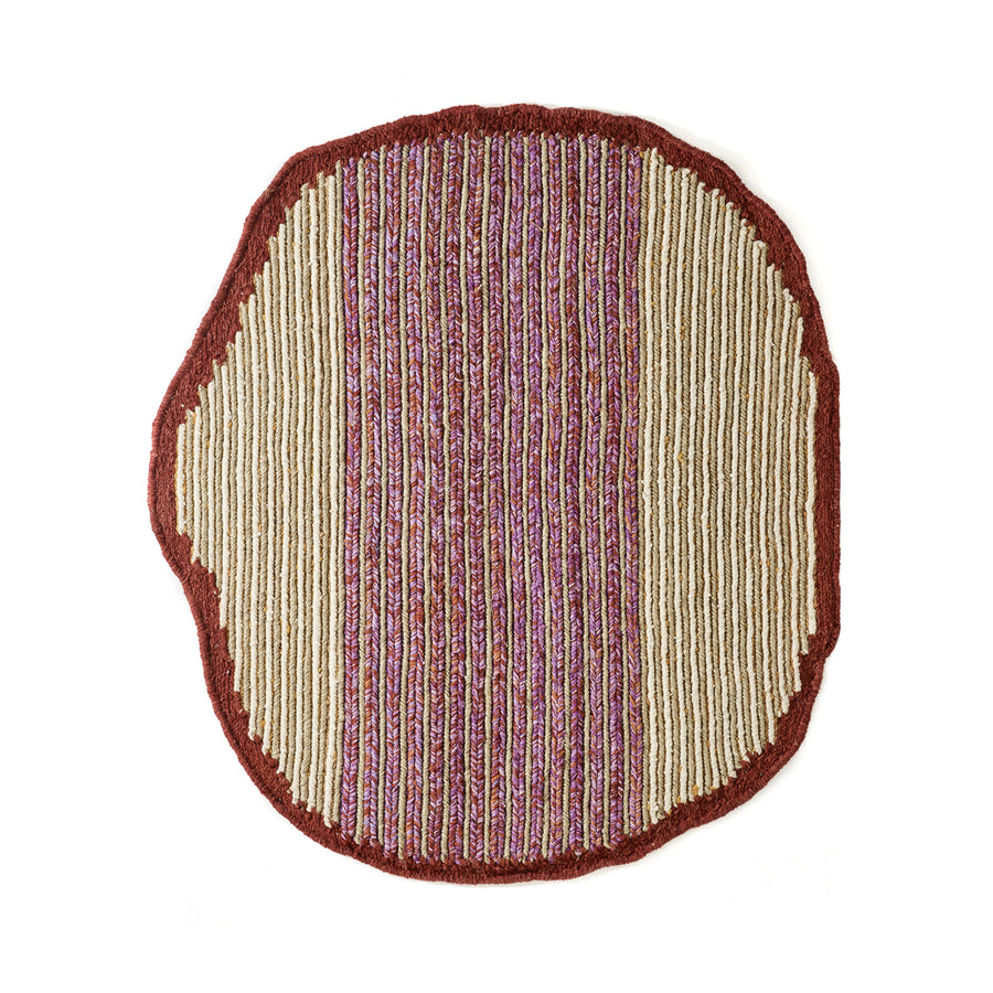The Ames Uilas Rug by Ames is round with an irregular shape, a red border, and vertical stripes in beige, red, and purple for a textured, woven look inspired by handmade wool rugs.