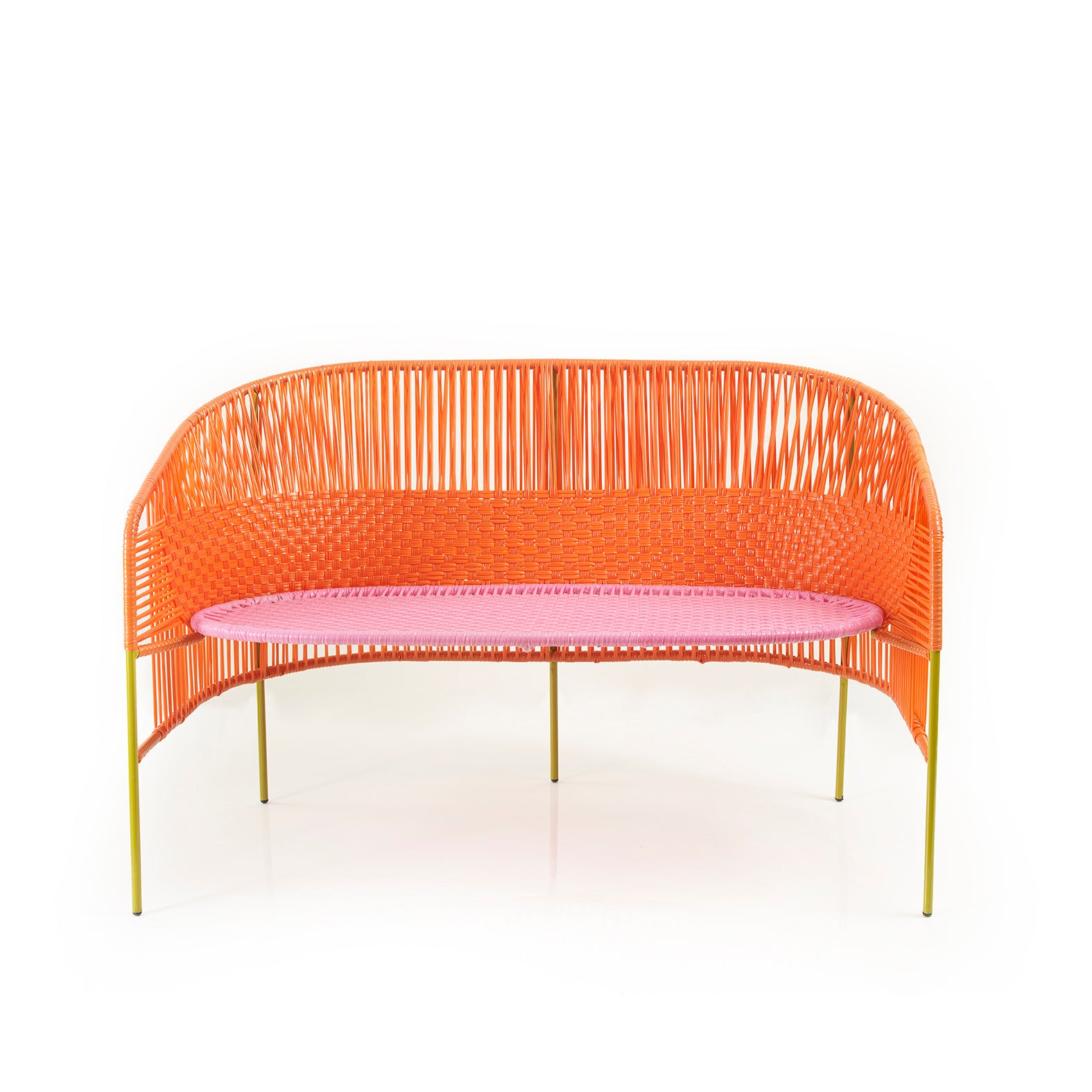 The Caribe Sofa by Ames features a modern orange woven design using traditional momposino techniques. It includes a pink cushion and rounded back, supported by four slender yellow legs. Ideal as Caribbean coastal outdoor furniture, it is beautifully set against a plain white backdrop.