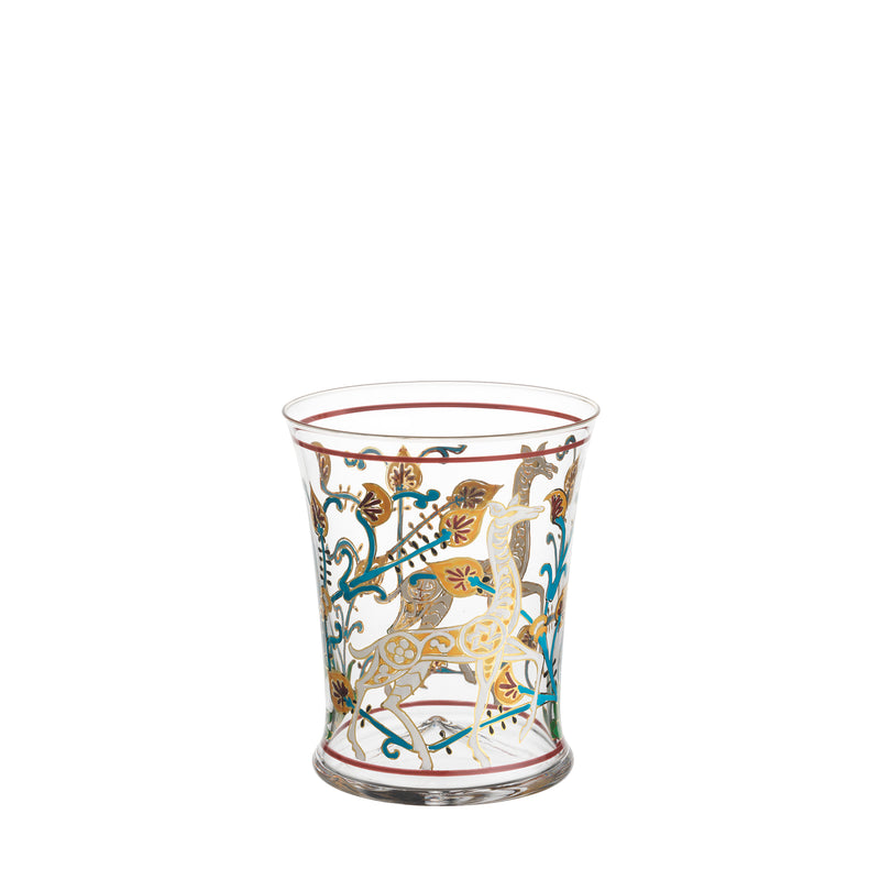 The Lobmeyr Alhambra Tumbler features Franz Schmoranz-inspired hand-painted designs with gold and vibrant blue, red accents. Its adorned with intricate patterns of stylized animals and foliage motifs on clear crystal, highlighting elegant artistry.